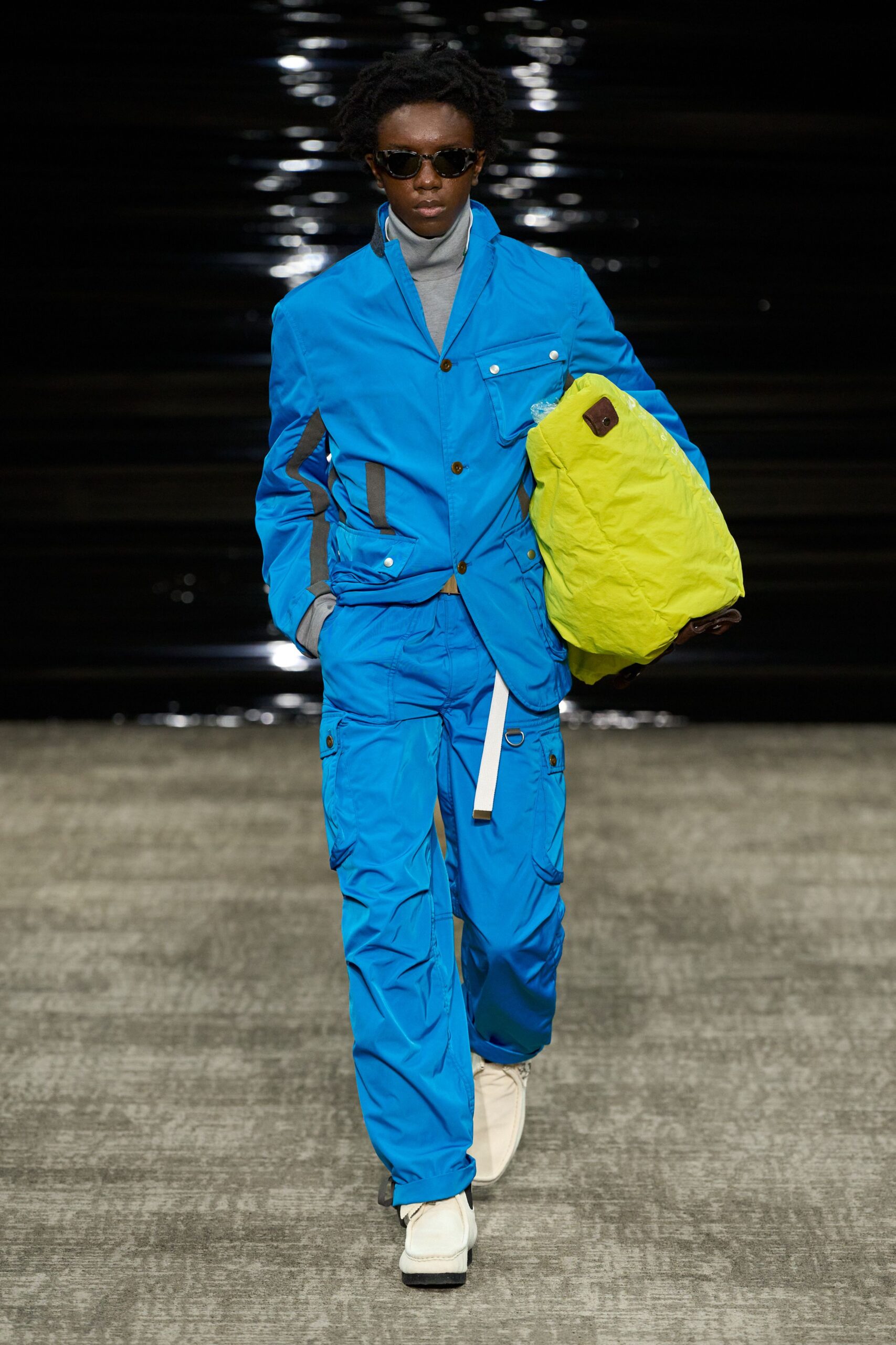 blue fitted suit with green bag