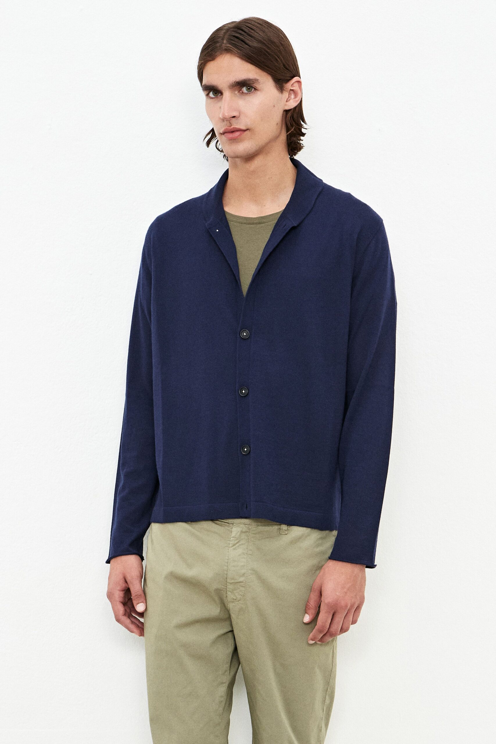 navy jacket green shirt beige pants