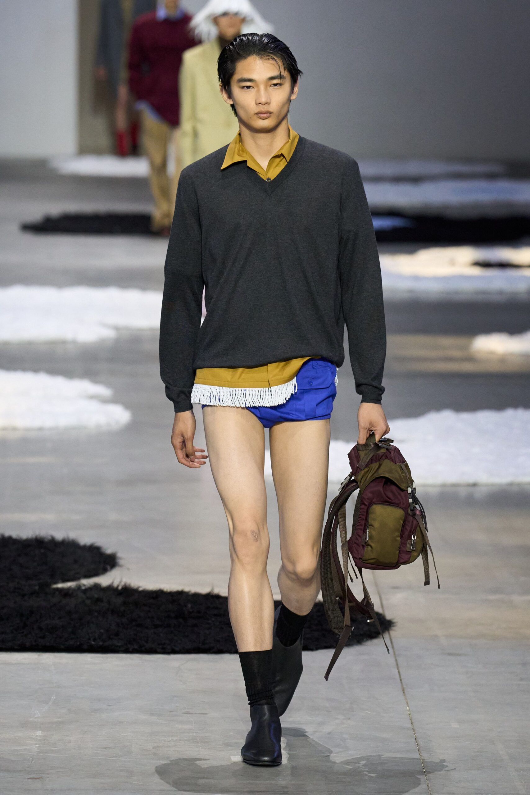 gray sweater yellow shirt blue shorts