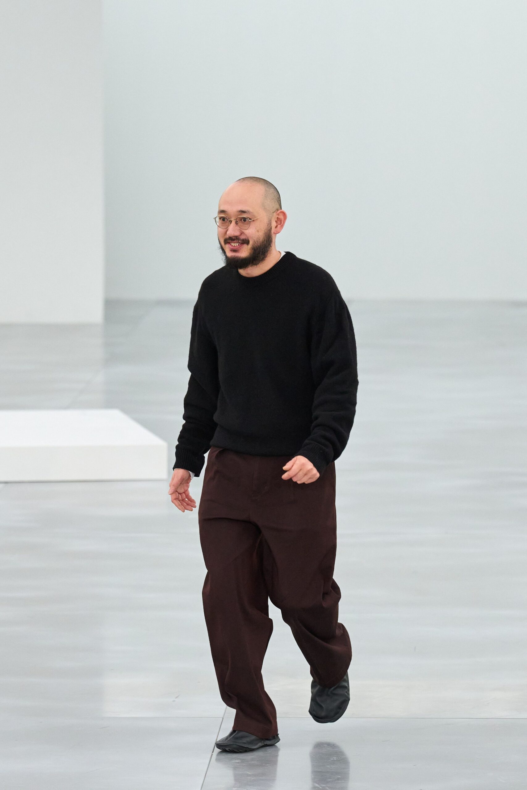black sweater brown pants black shoes