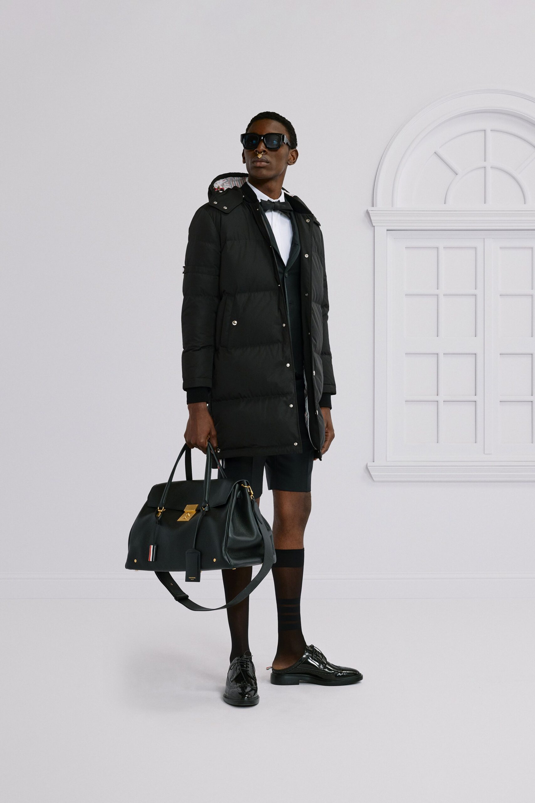 black coat with shorts and sunglasses