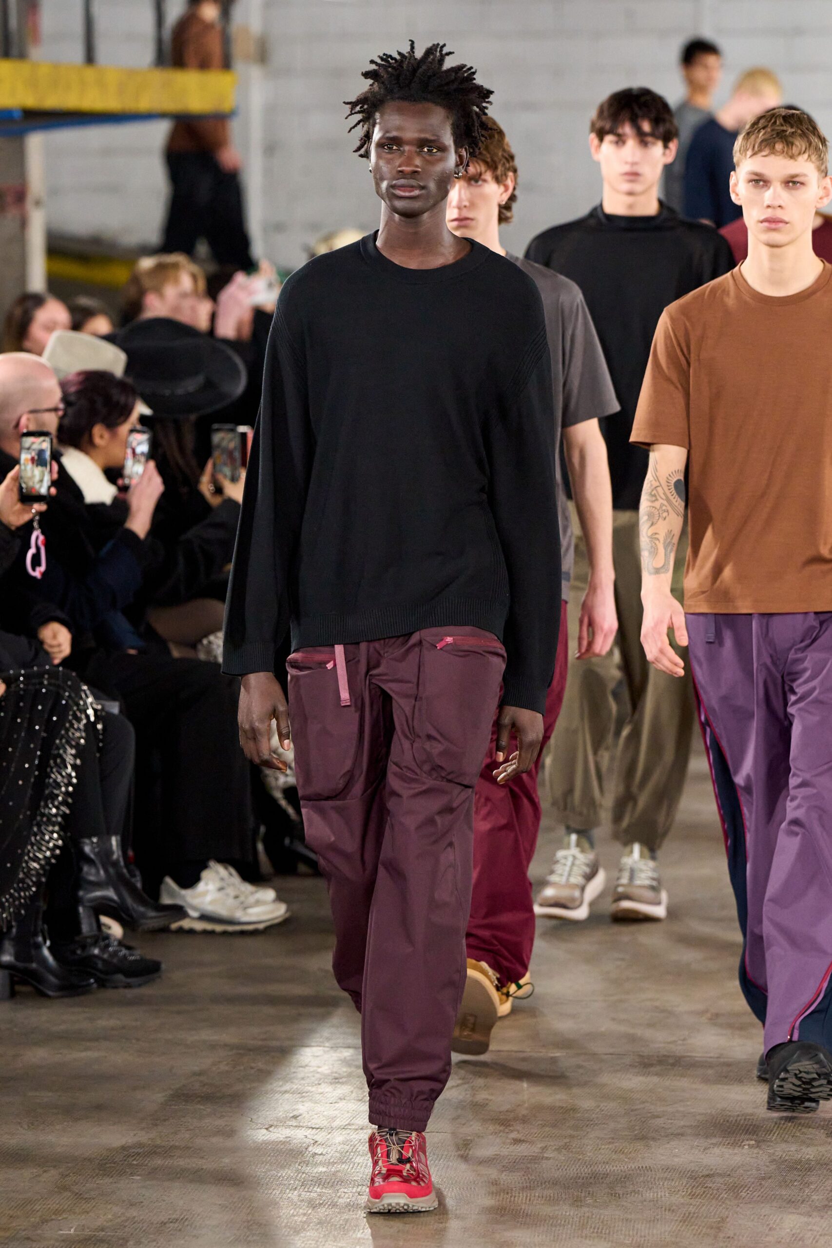 black relaxed sweater with maroon pants