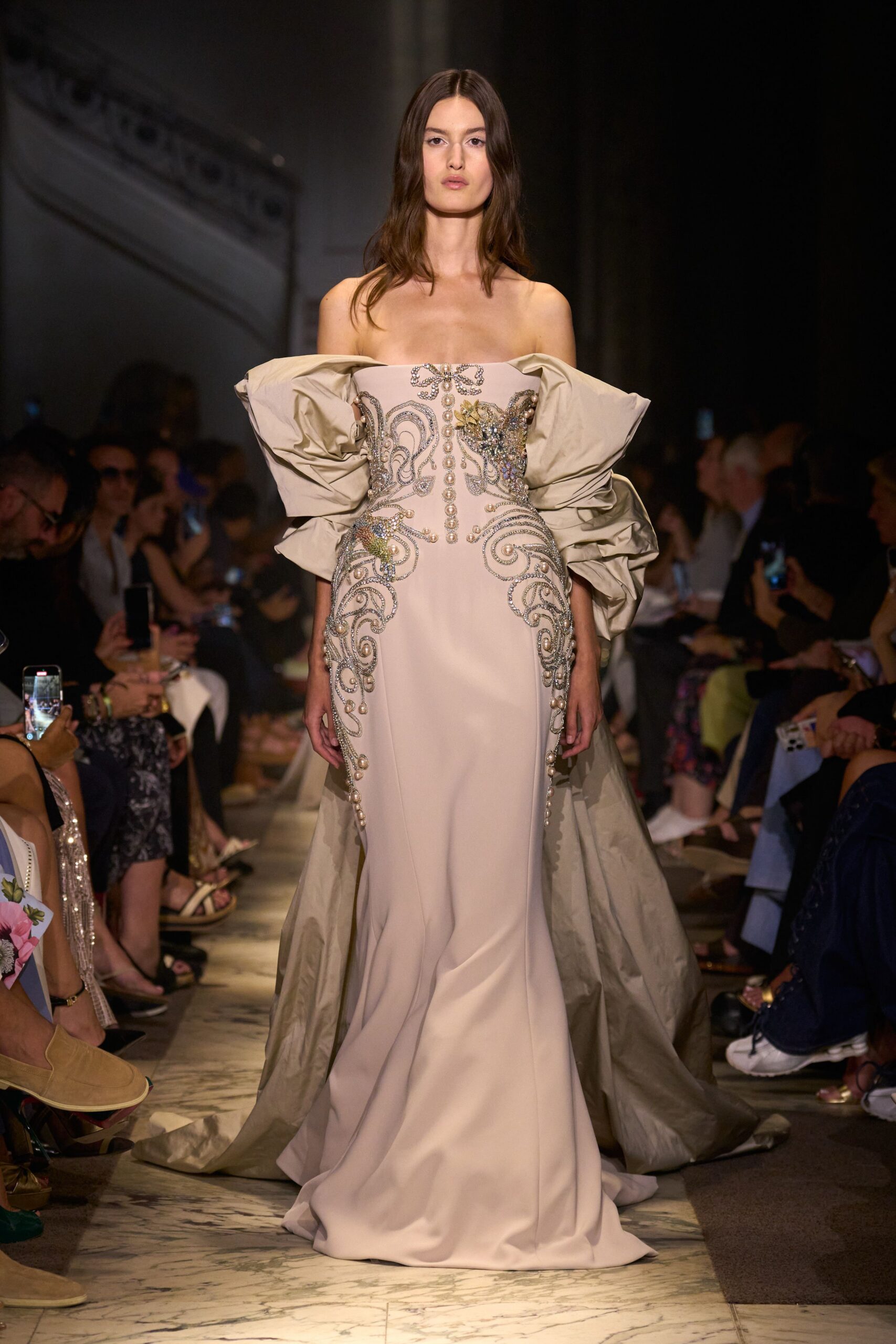 beige embroidered strapless gown with gray cape