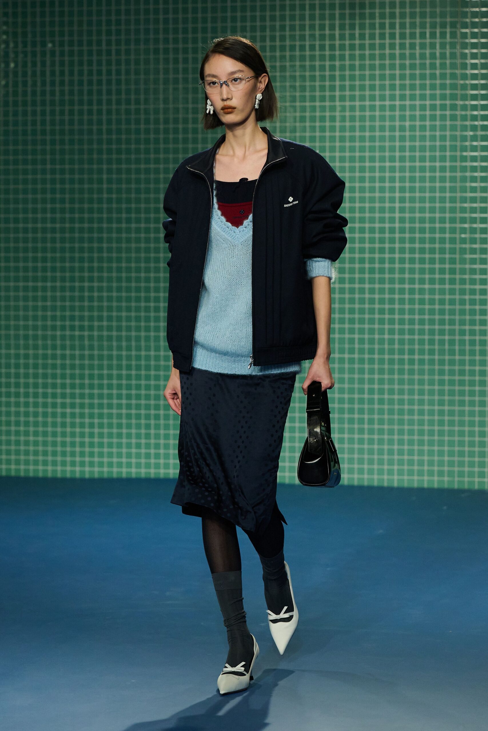 black jacket blue top navy skirt