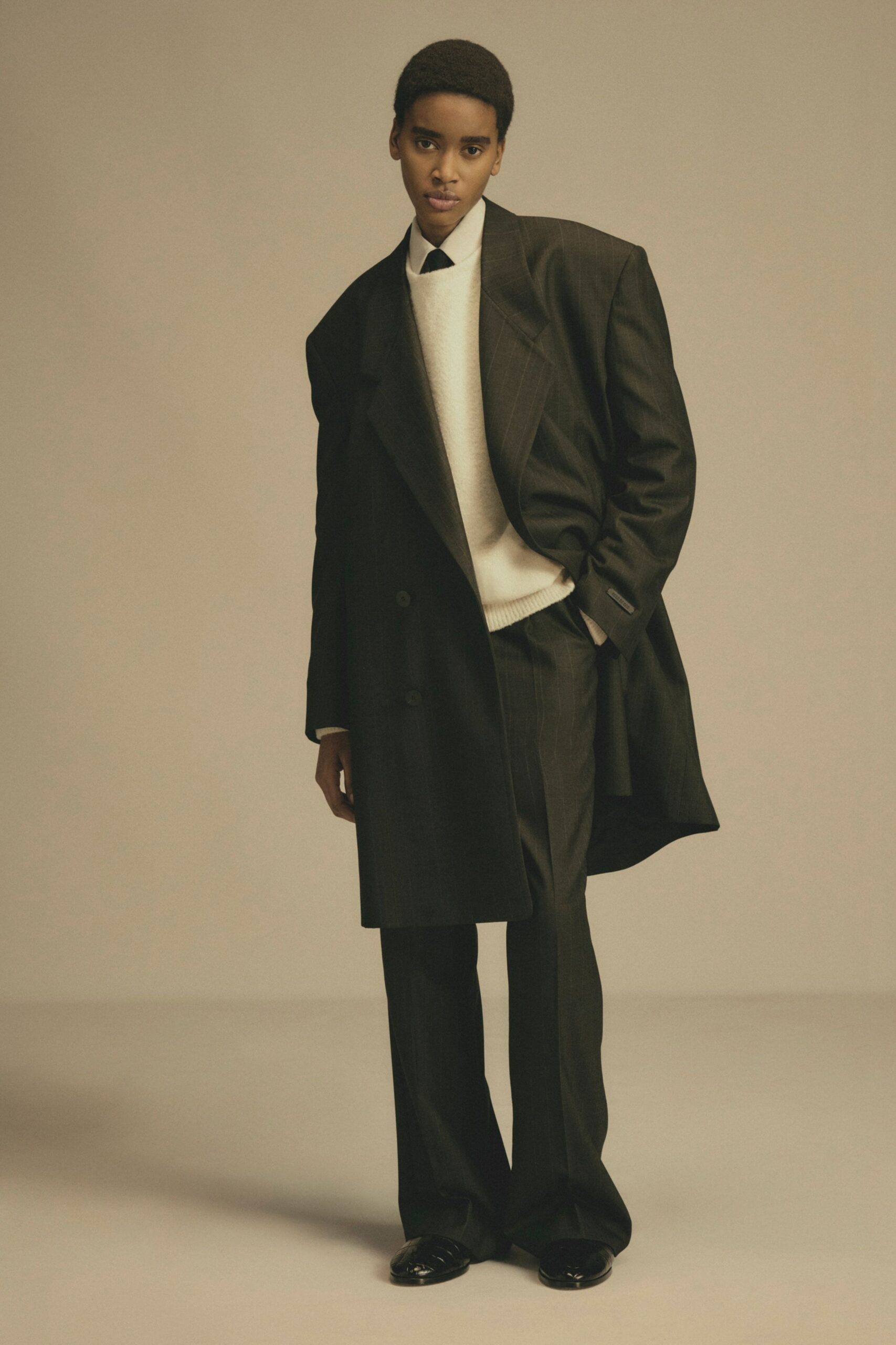black tailored blazer with white sweater