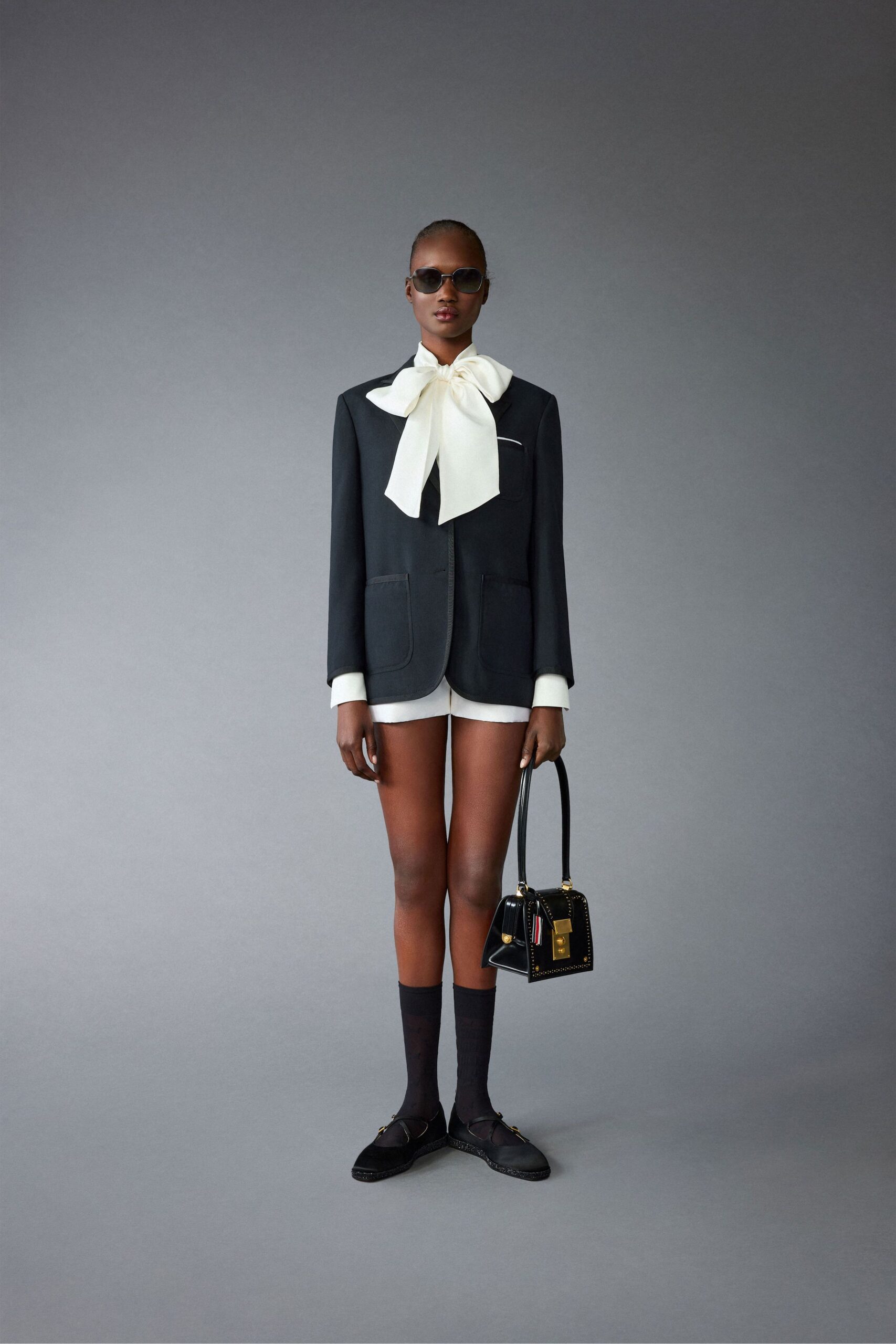 black tailored blazer with white shorts