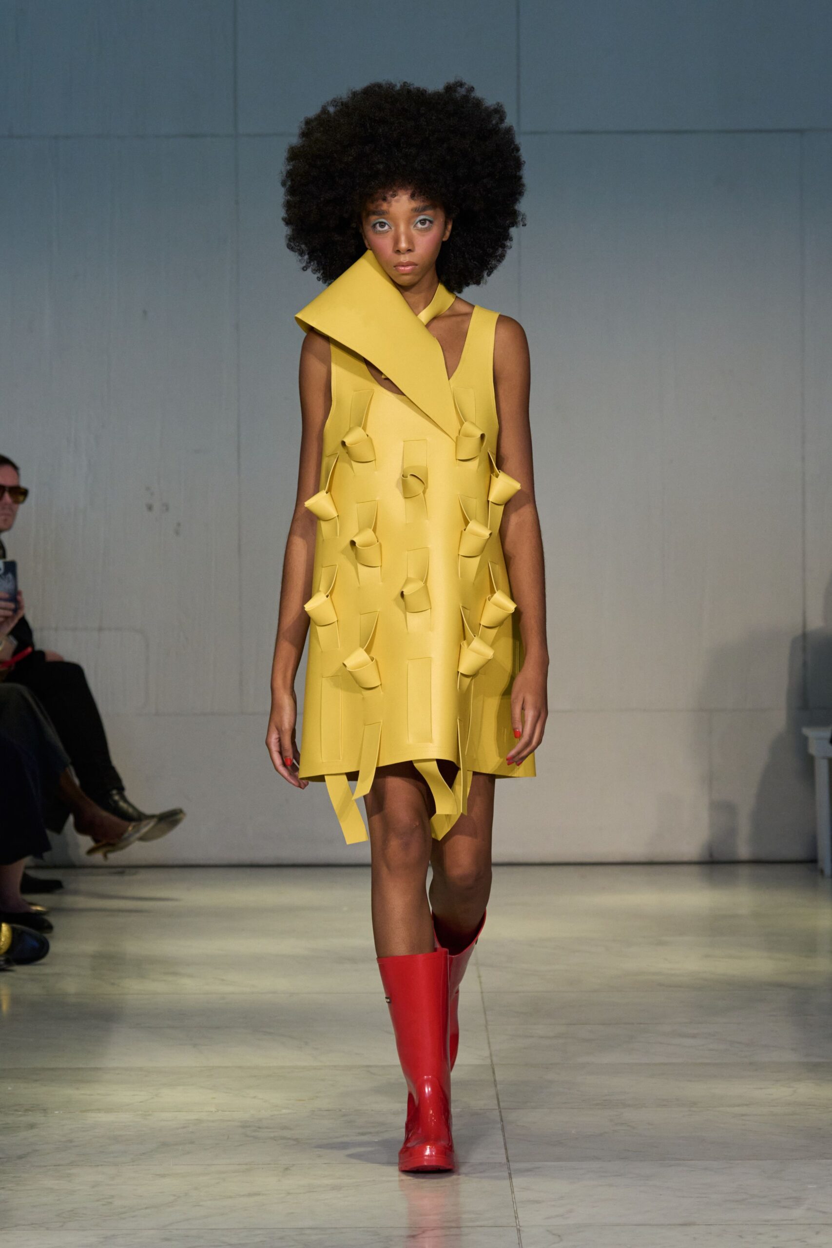 yellow pleated mini dress with red boots
