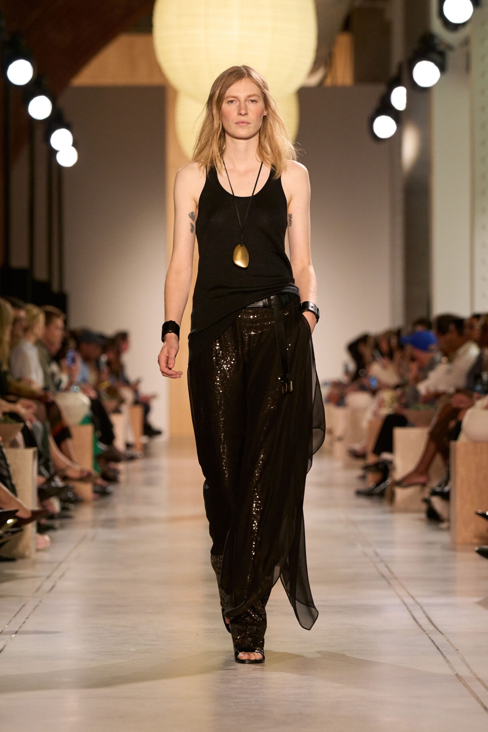 black fitted top with sequined pants