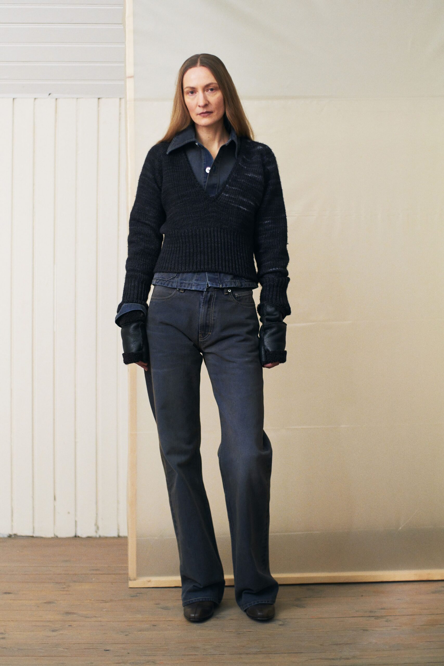 black sweater blue shirt gray pants