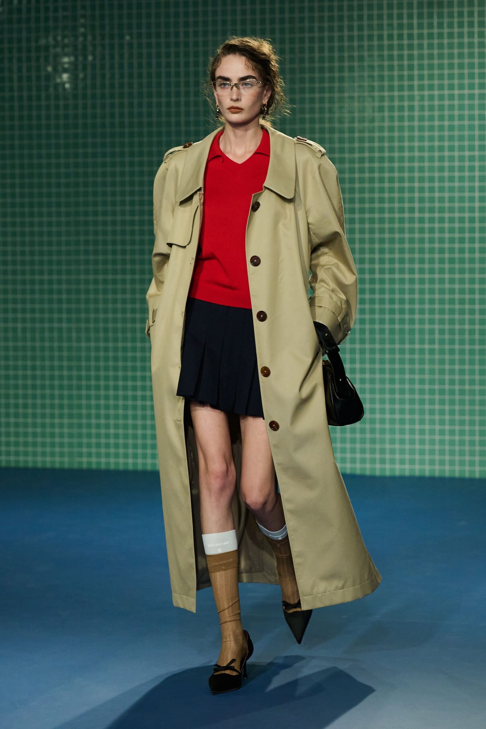 beige trench coat with red top