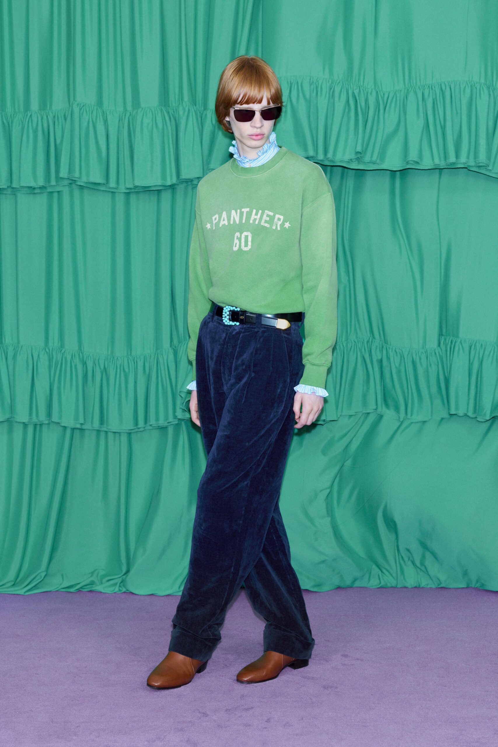 green relaxed sweater with blue pants