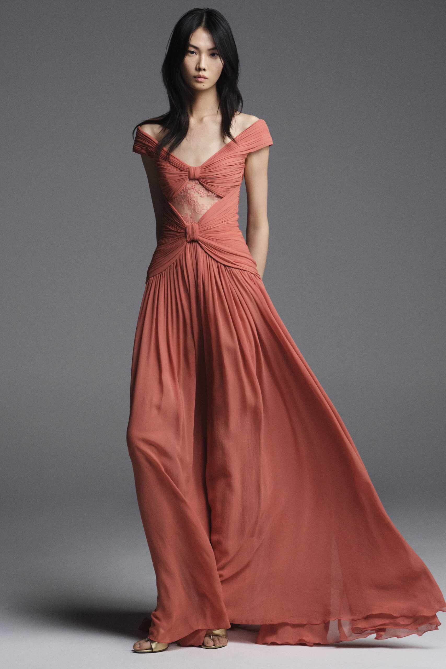 coral silk sleeveless off-shoulder fitted draped pleated gown