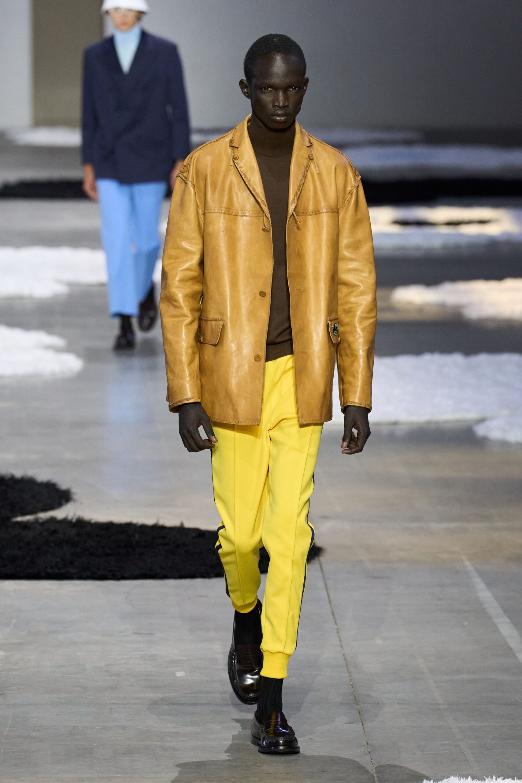 brown leather jacket with yellow pants