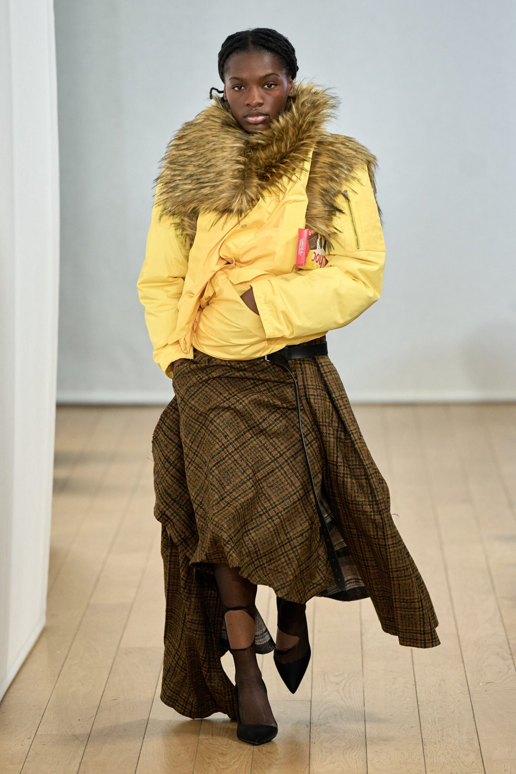 yellow faux-fur jacket and brown plaid skirt