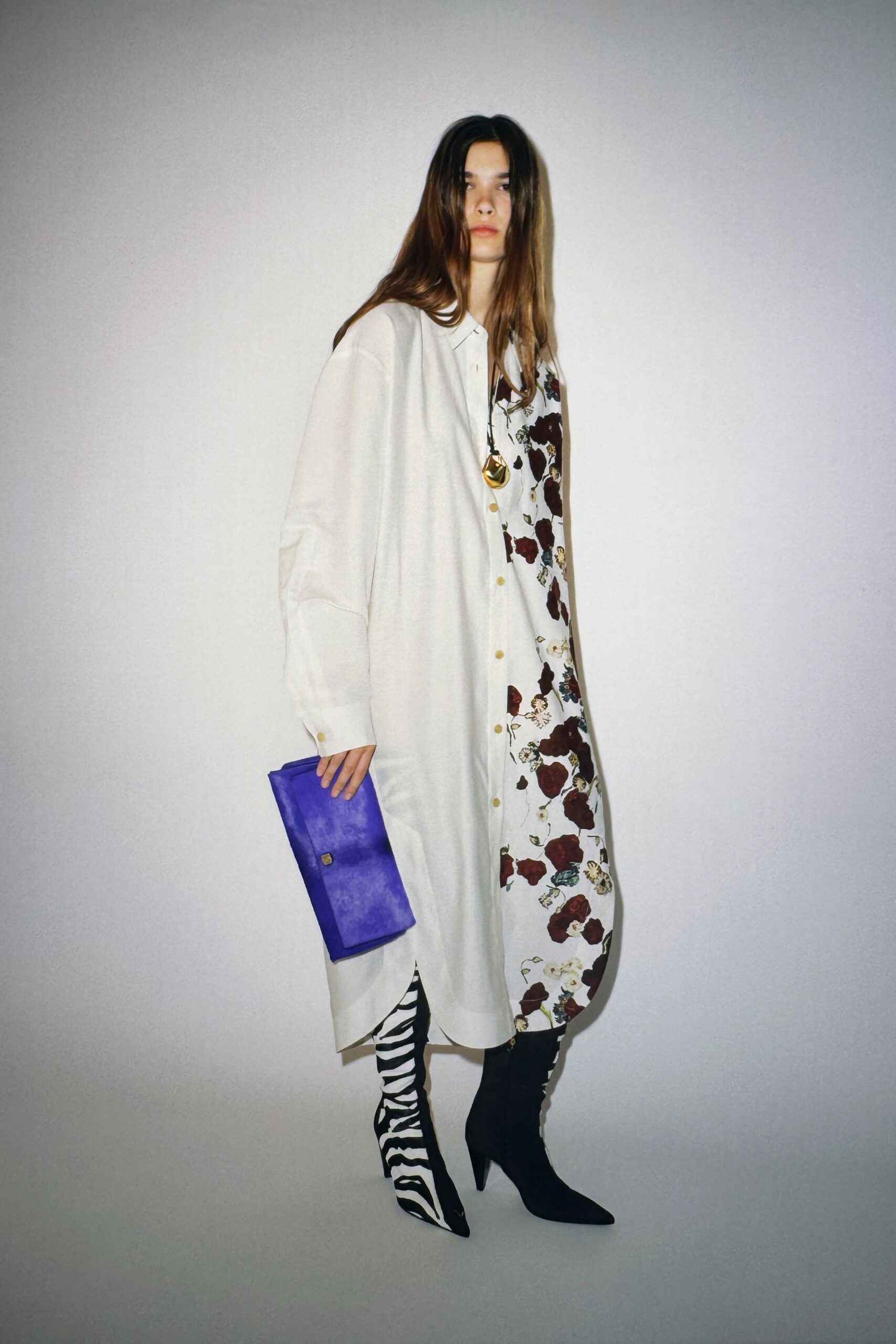 white printed shirt-dress with purple clutch