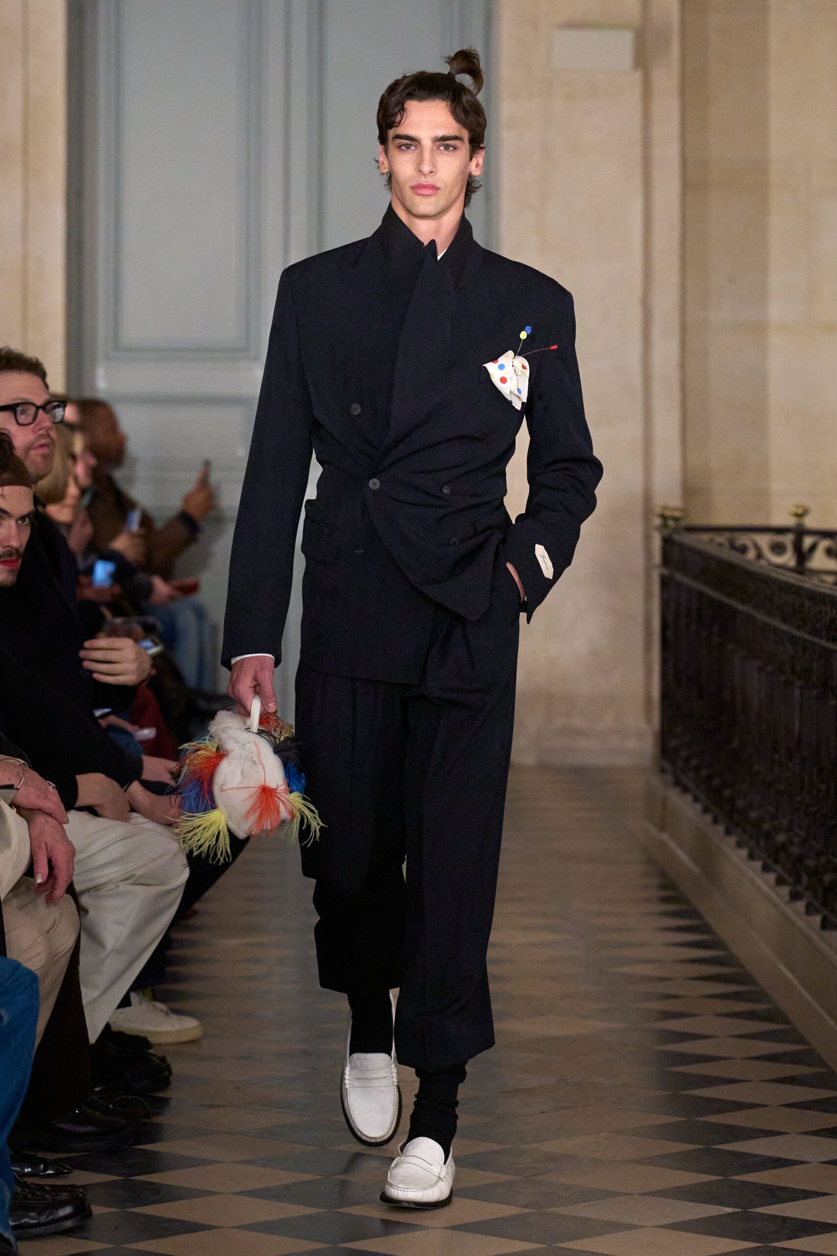 black tailored suit with multi-colored bag