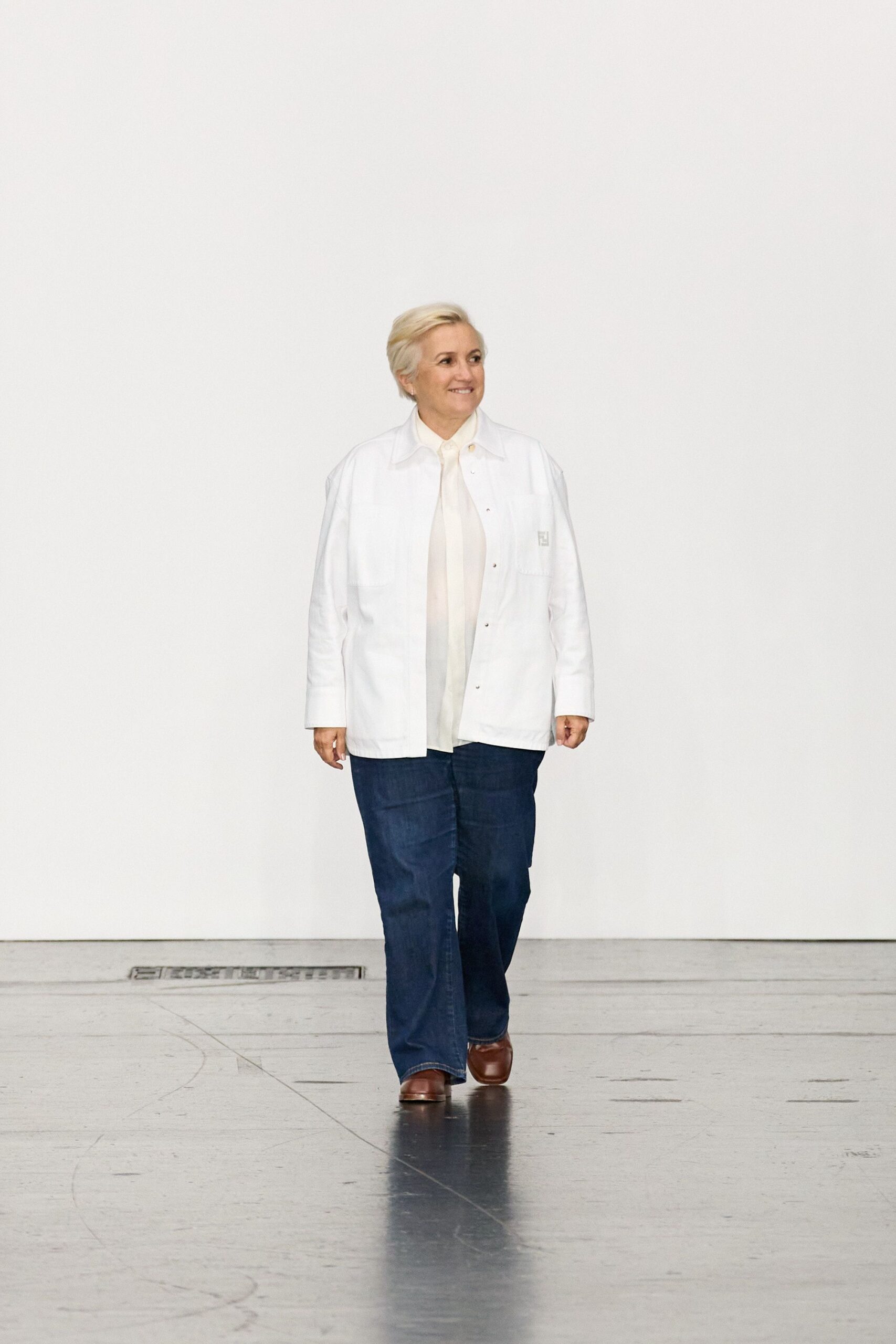 white jacket beige shirt blue pants brown shoes