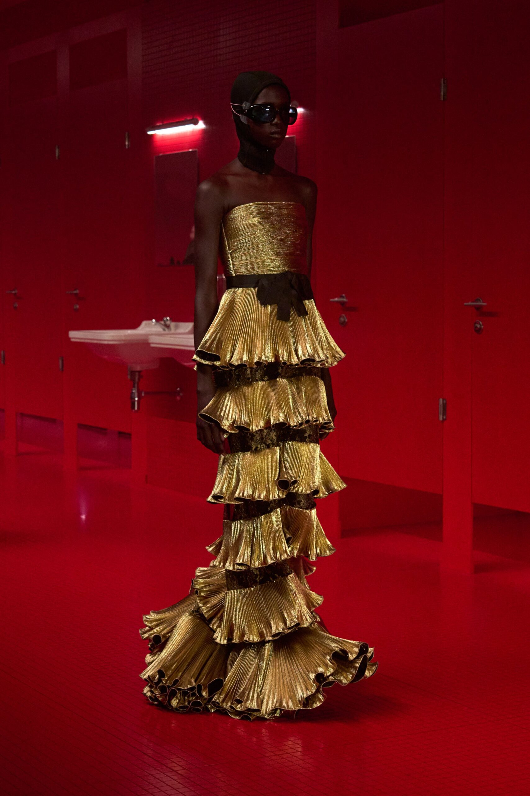 gold silk strapless fitted tiered pleated shiny gown