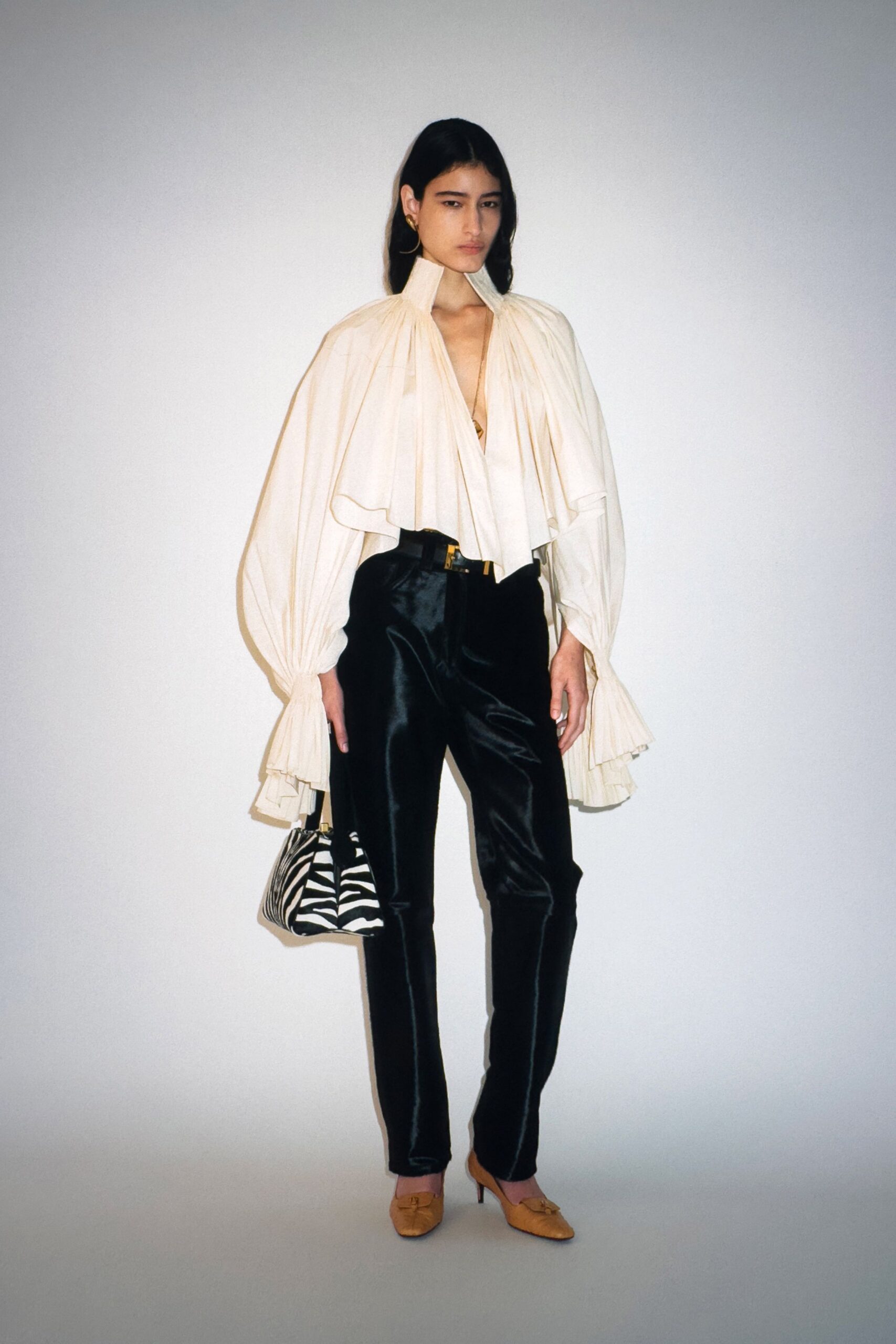 white ruffled top with black pants