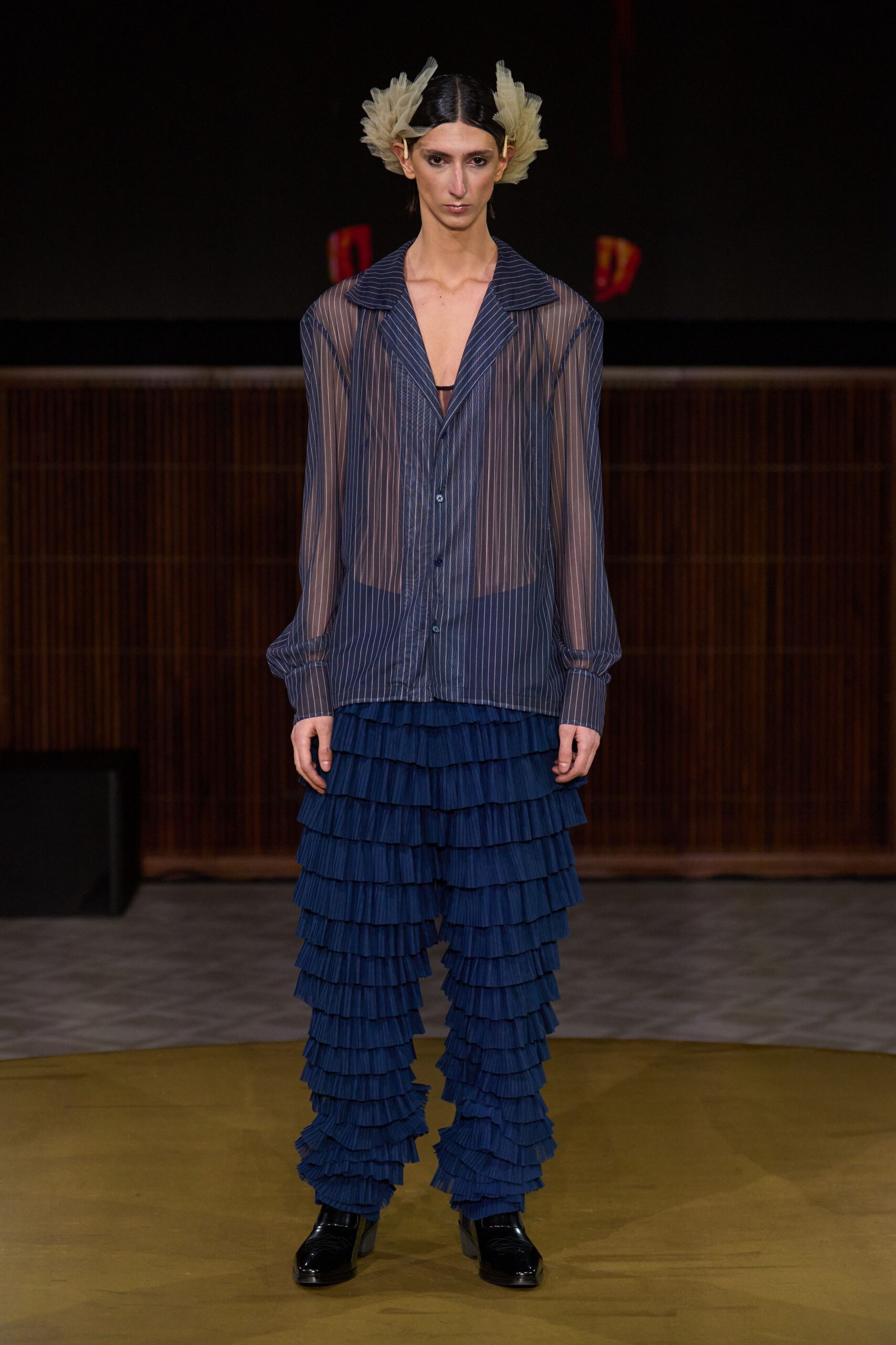 blue striped sheer shirt with pleated pants
