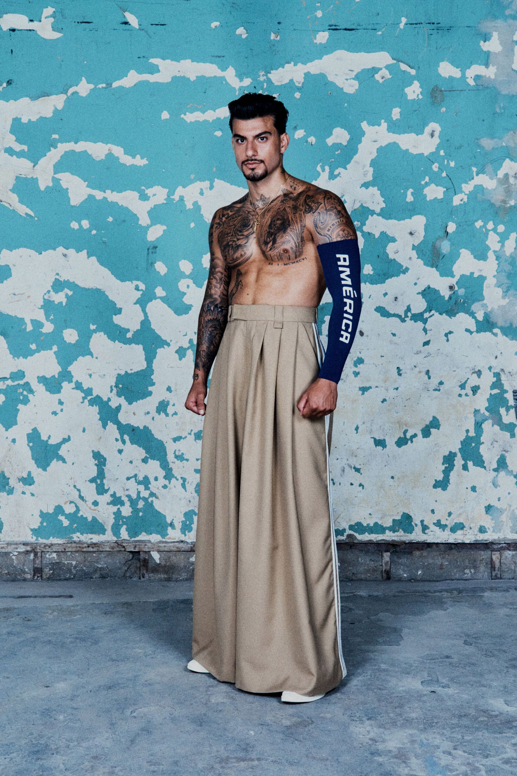 beige relaxed pants and blue fitted top