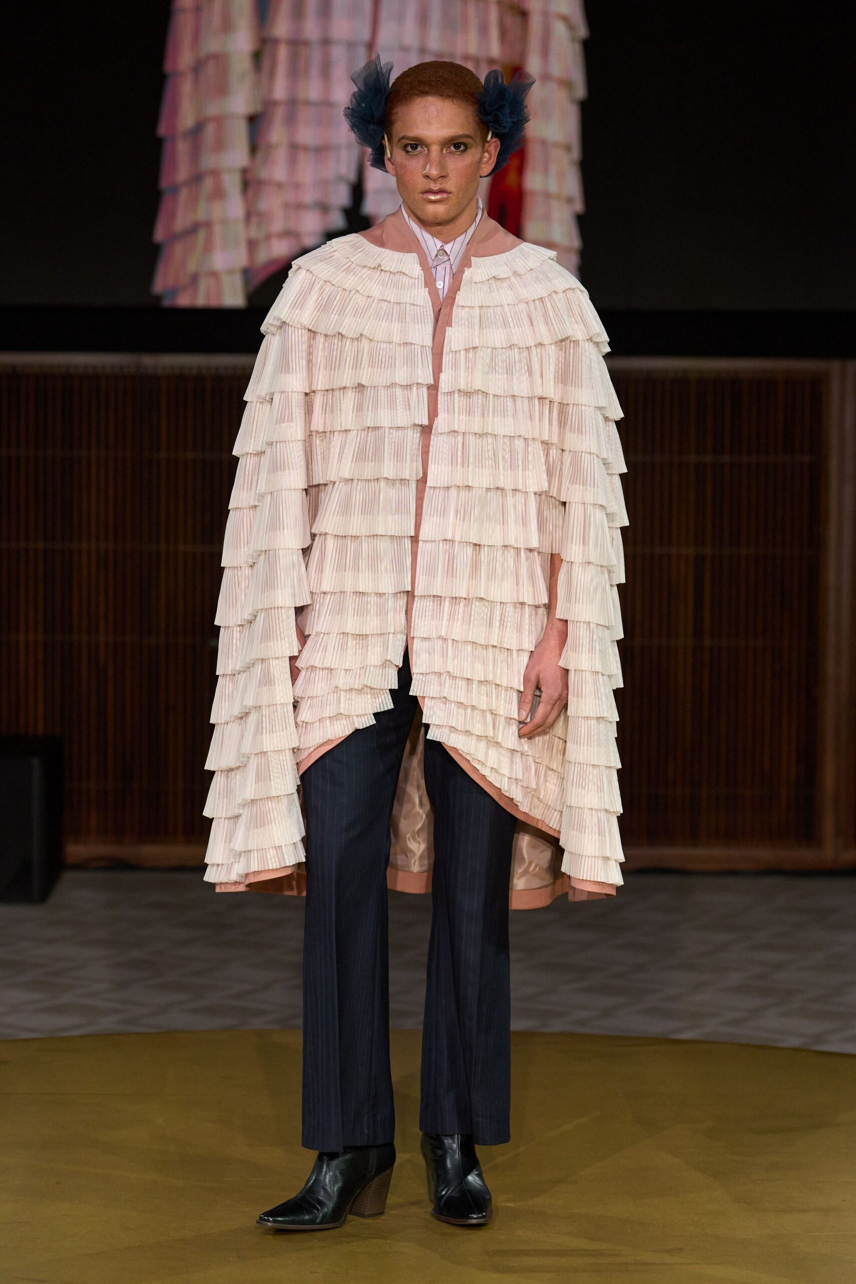 pink layered cape with black pants