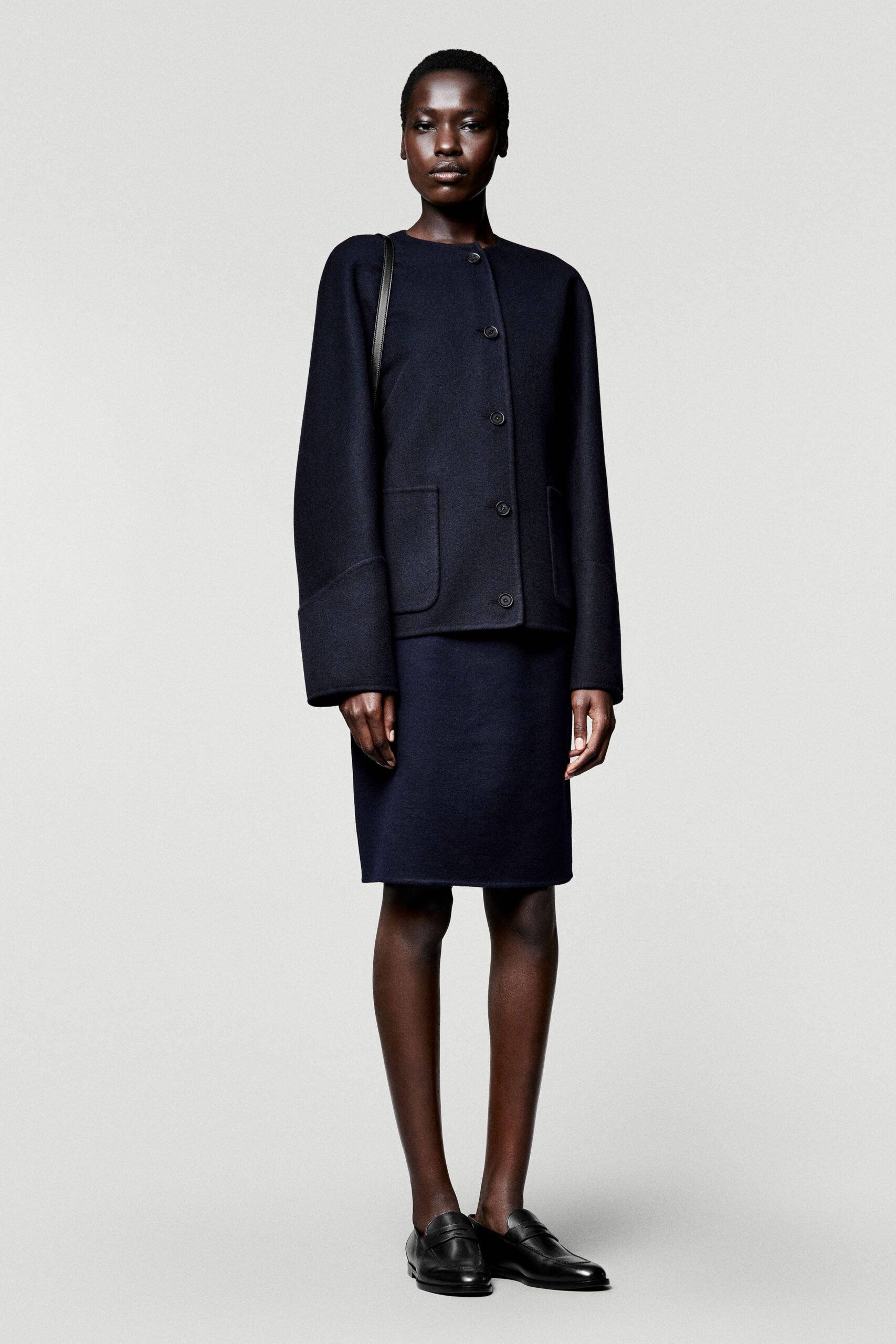 black wool long-sleeve collared relaxed buttoned jacket