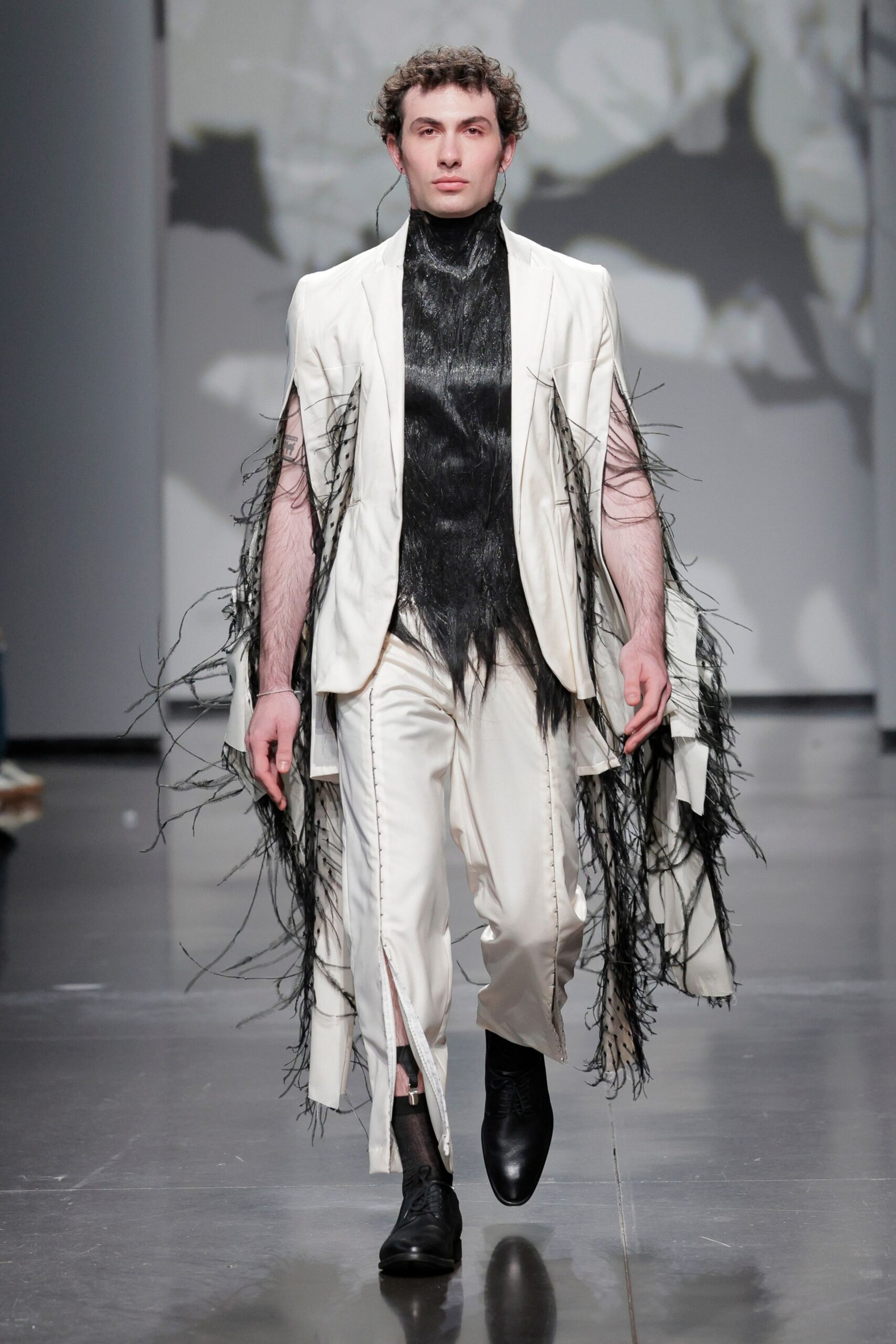white fringed suit with black shoes