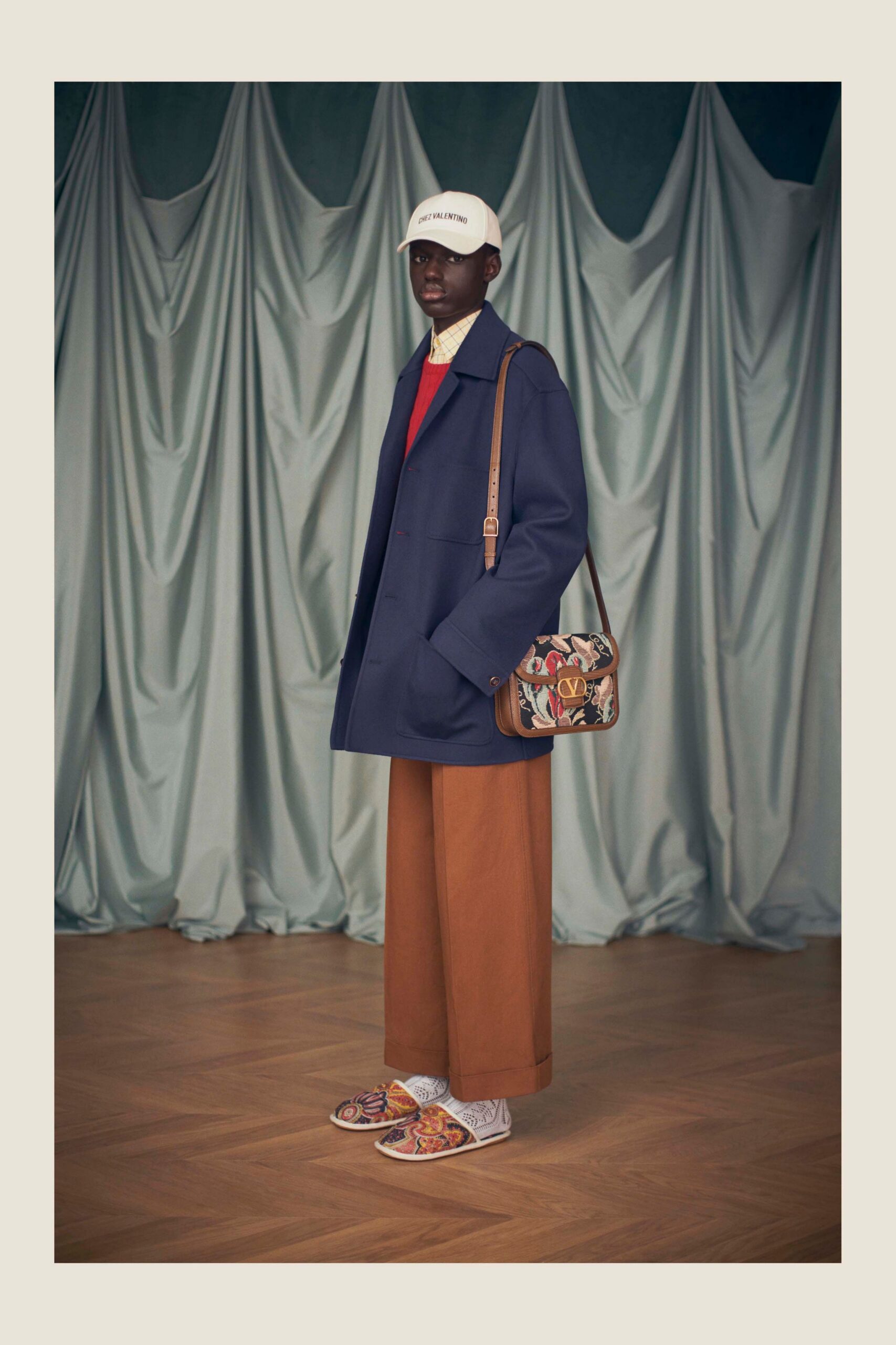 blue jacket red top brown pants