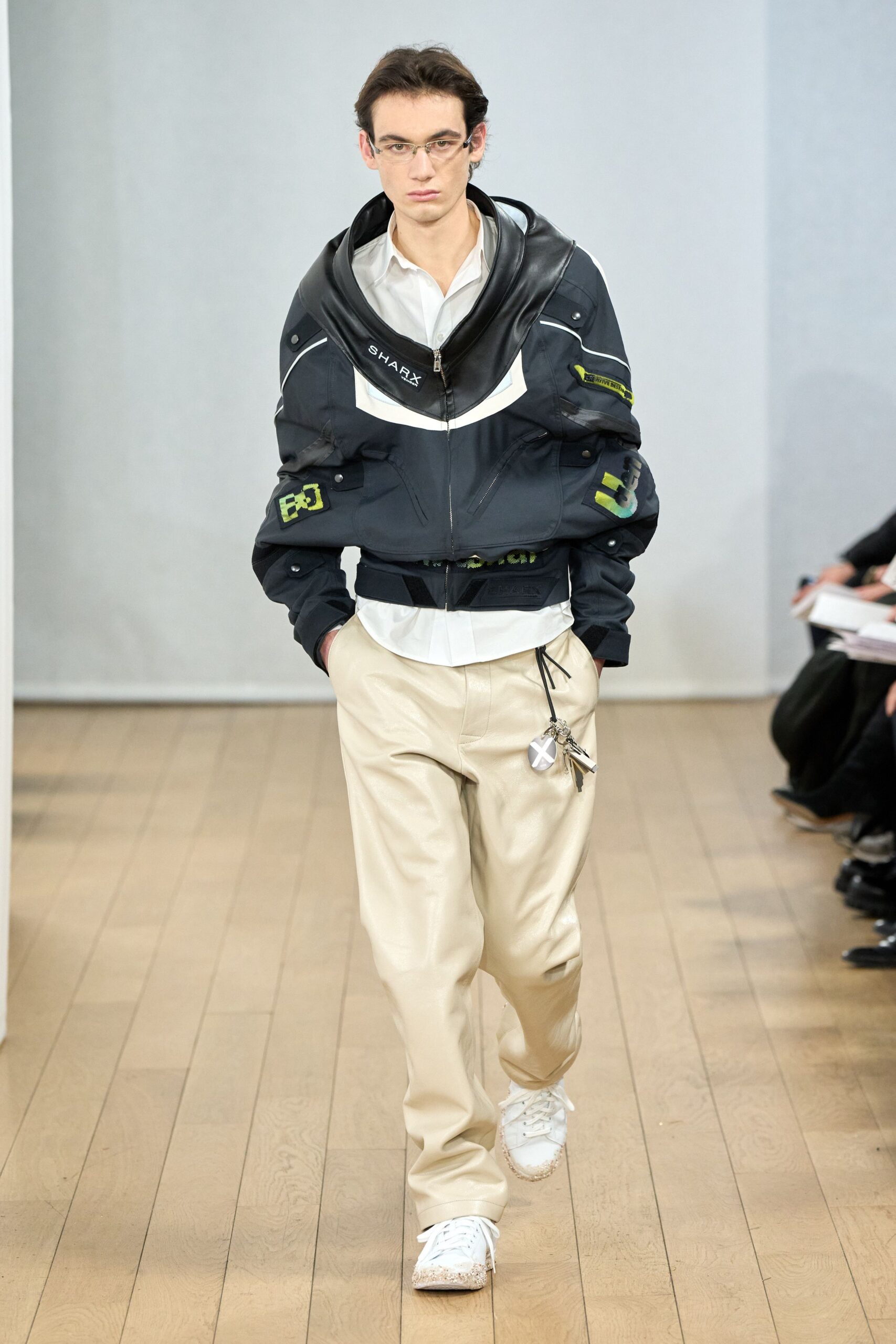 black jacket white shirt beige pants
