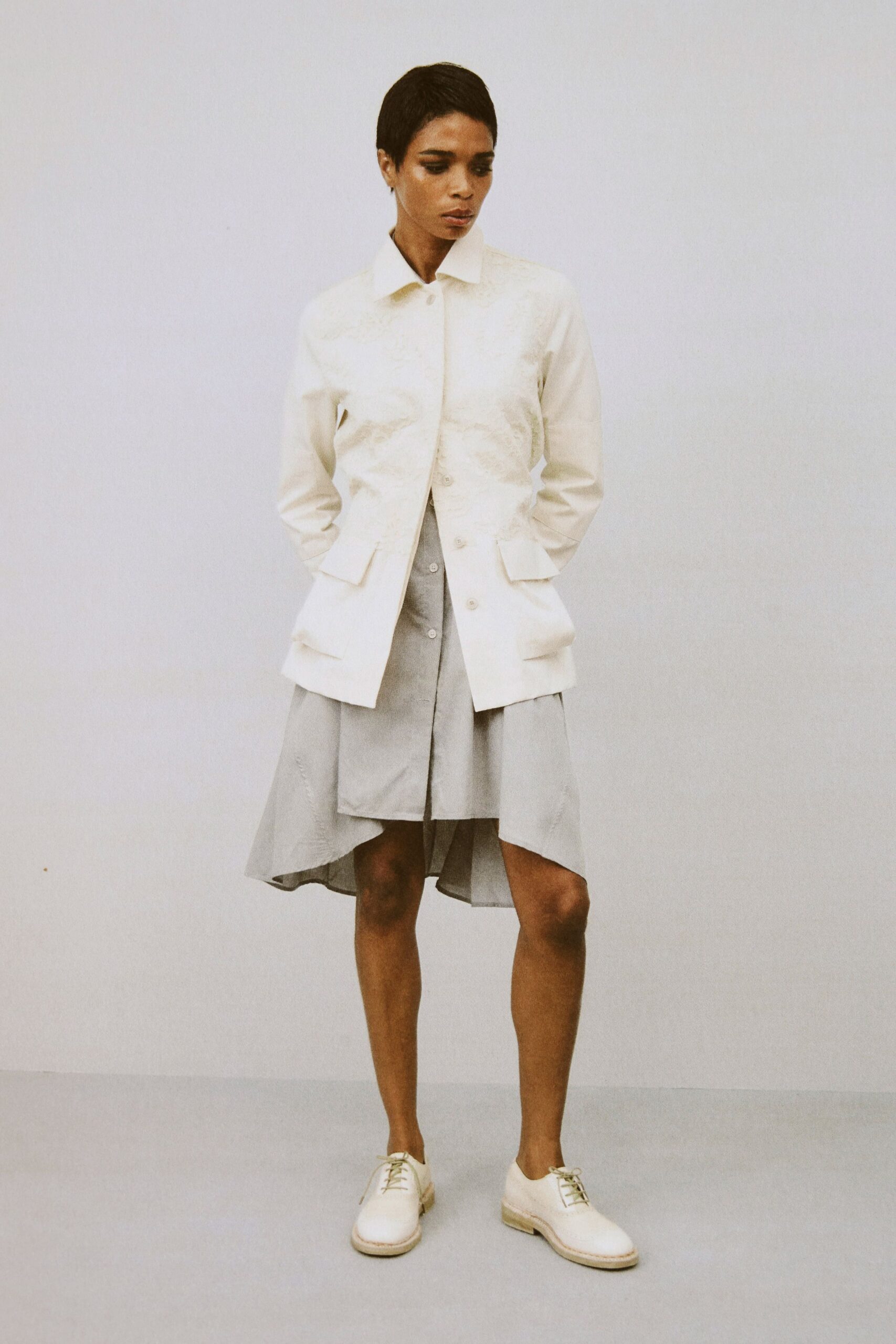 white jacket gray dress white shoes