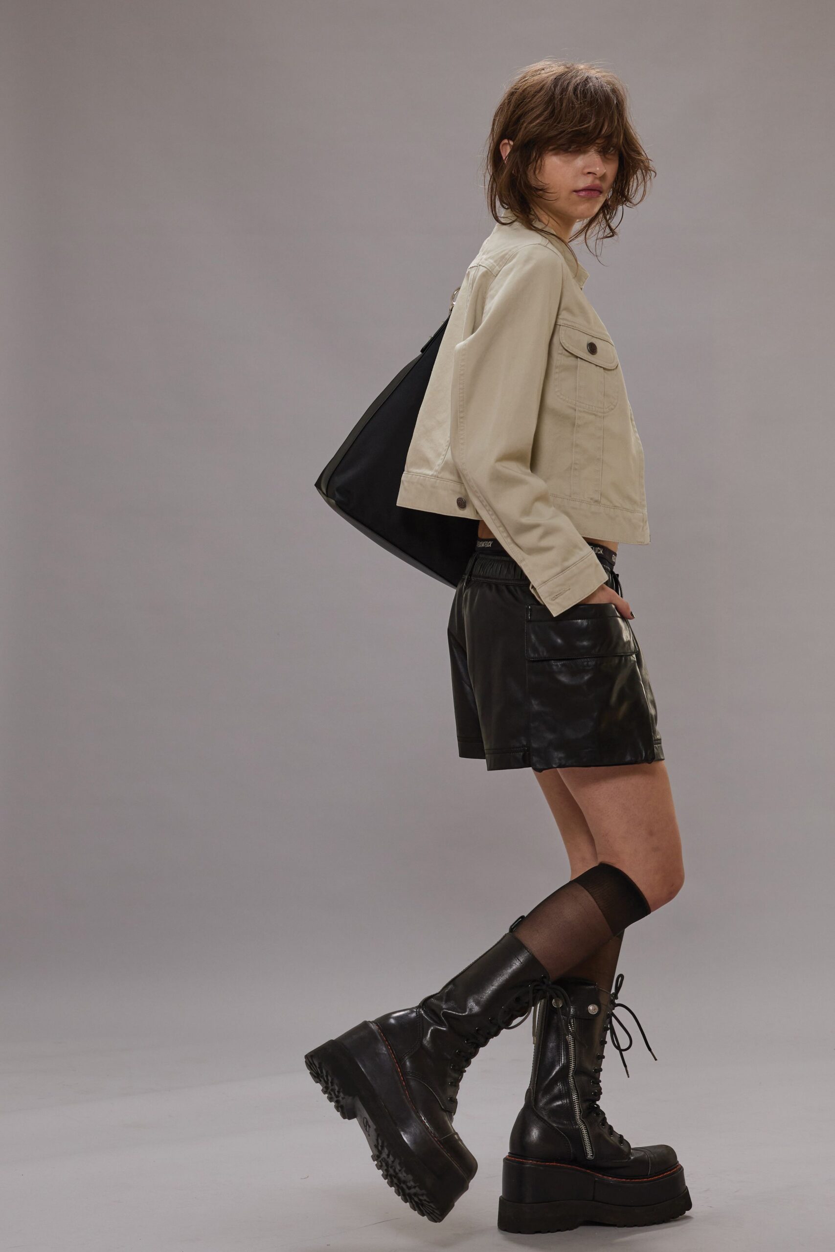 beige jacket black leather shorts