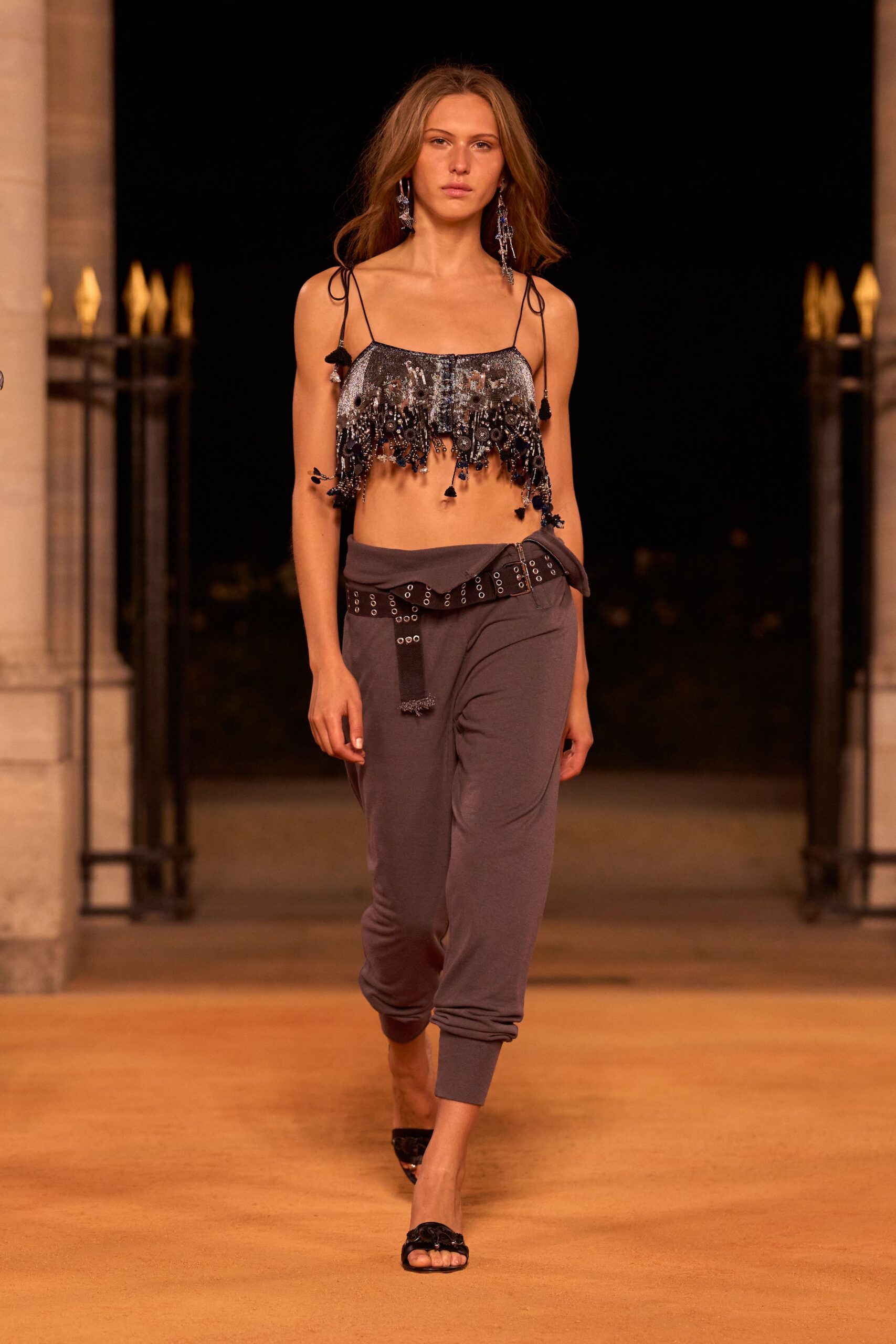 black fringed top and gray pants