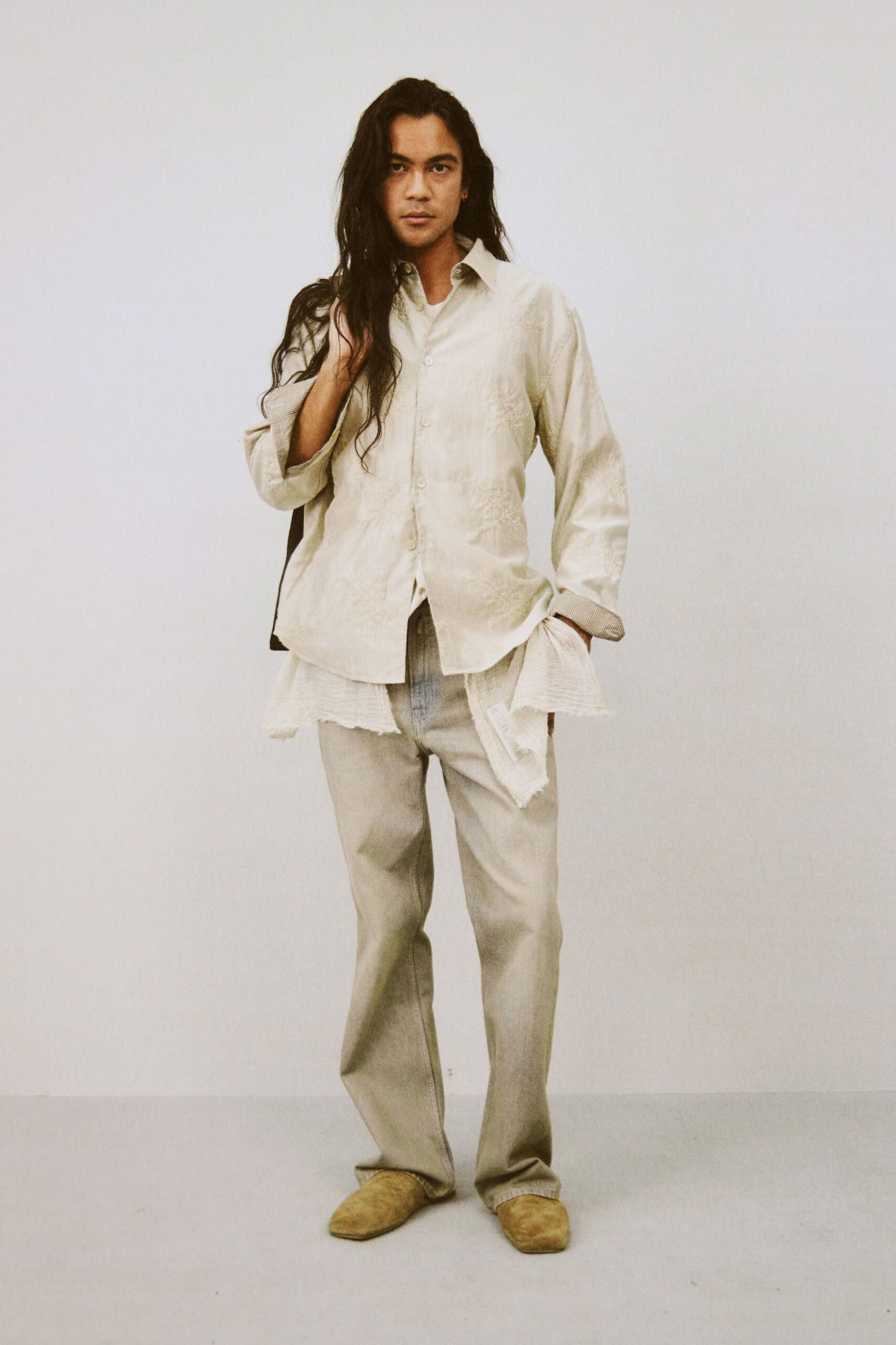 beige relaxed shirt and gray pants
