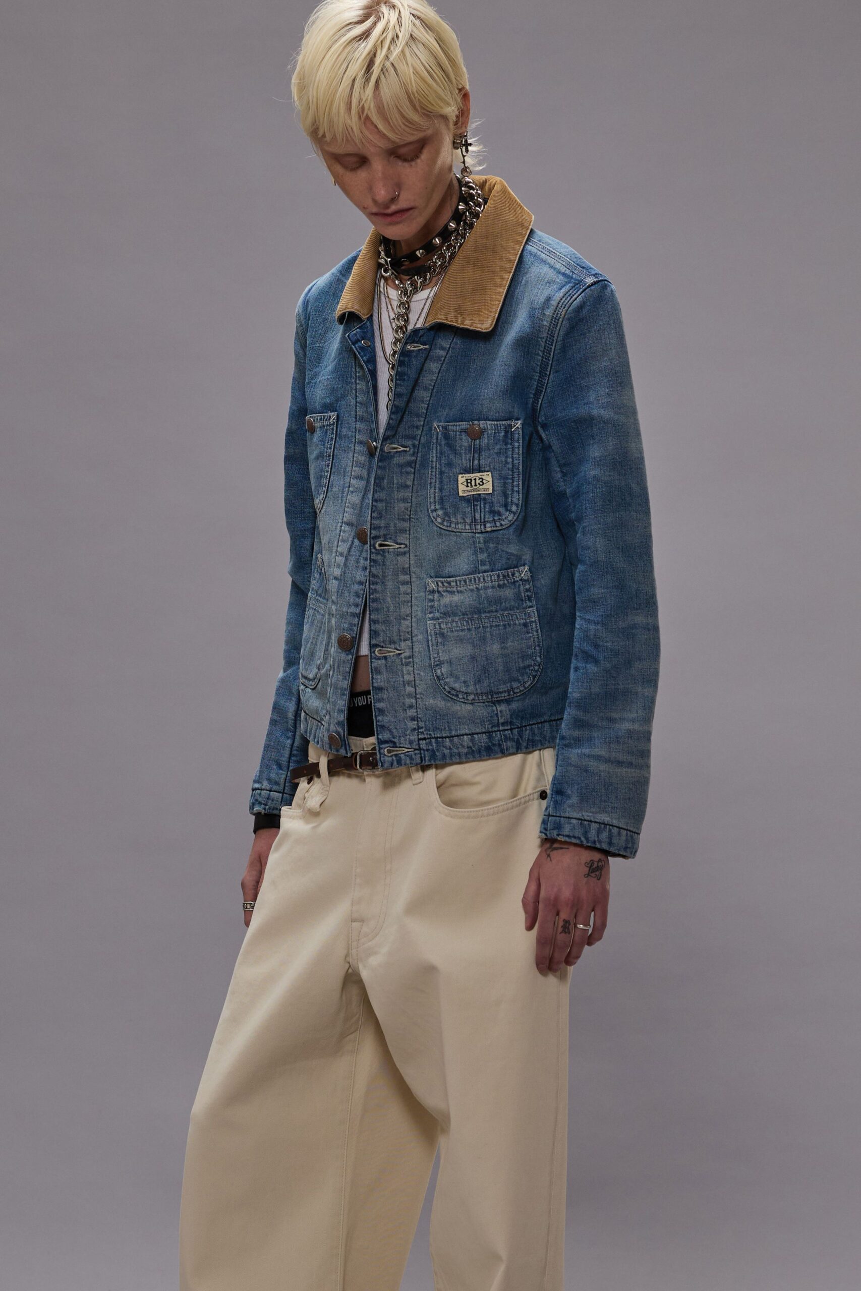 blue denim jacket and beige pants