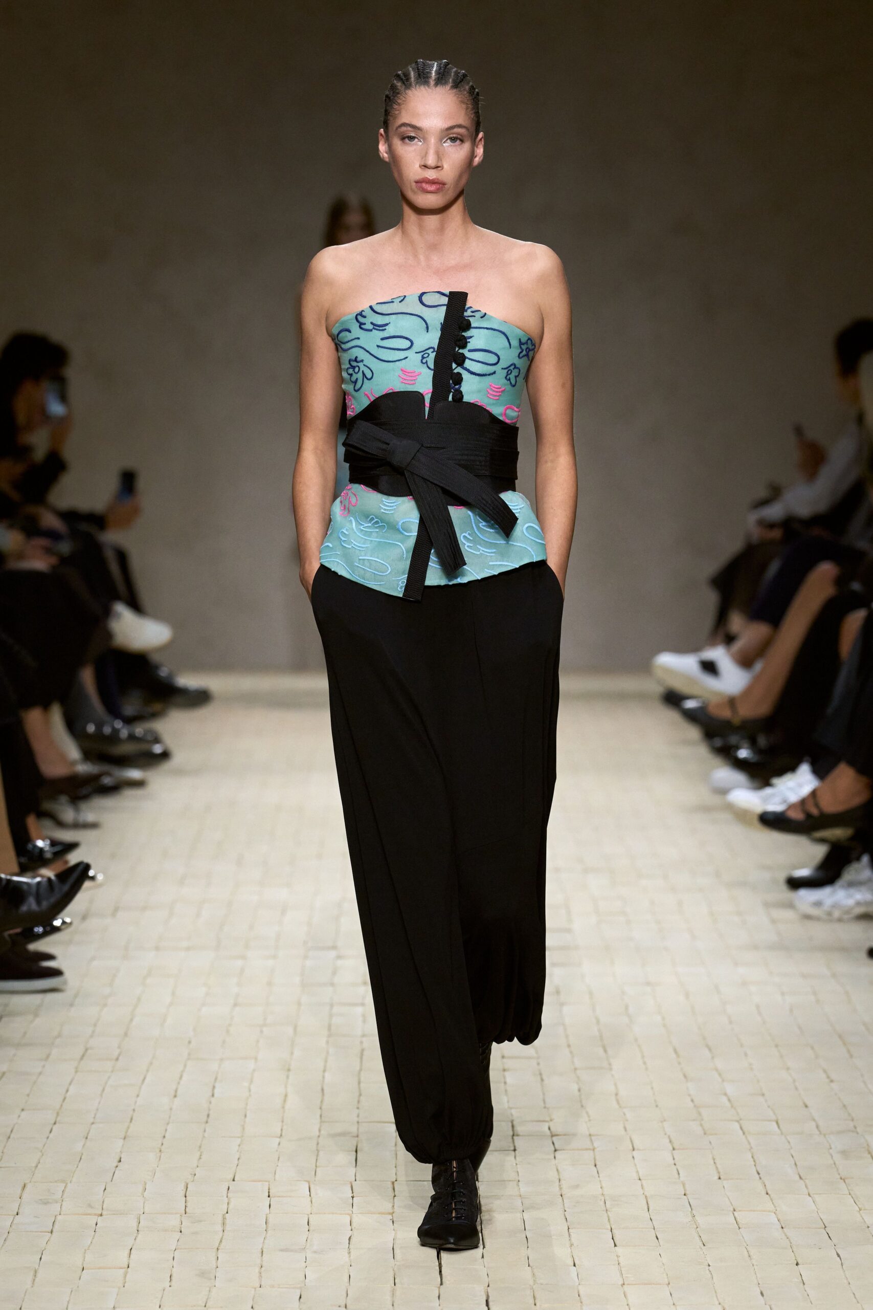 blue embroidered strapless top with black pants