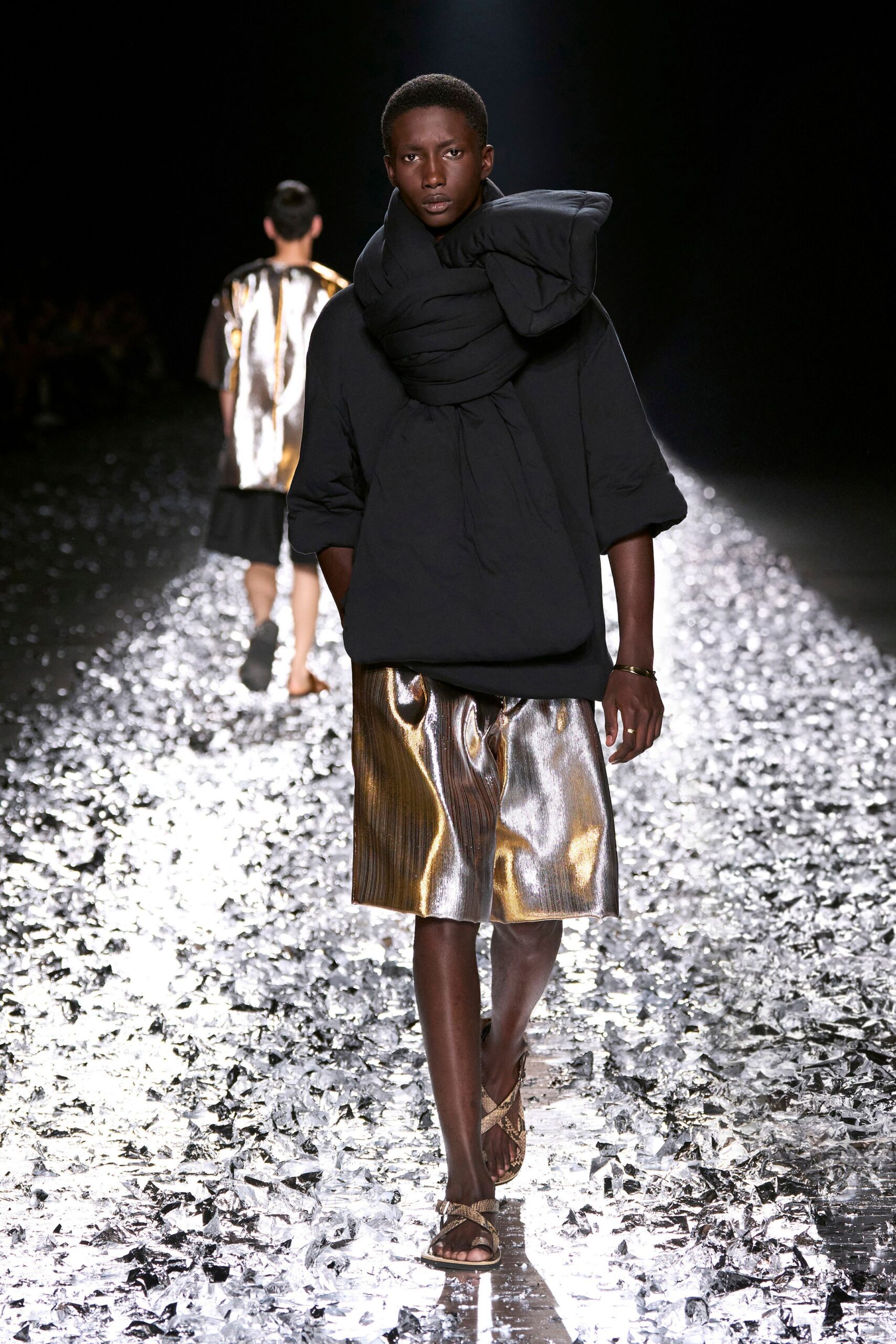 black relaxed top with gold pleated skirt