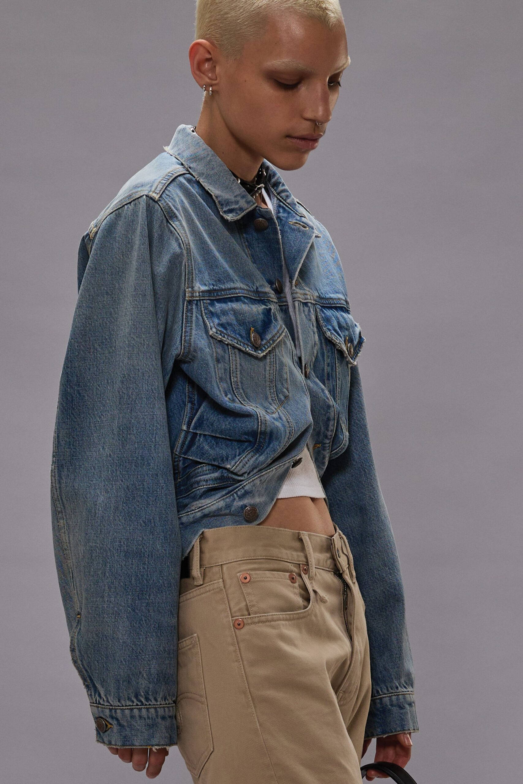 blue denim jacket and beige pants