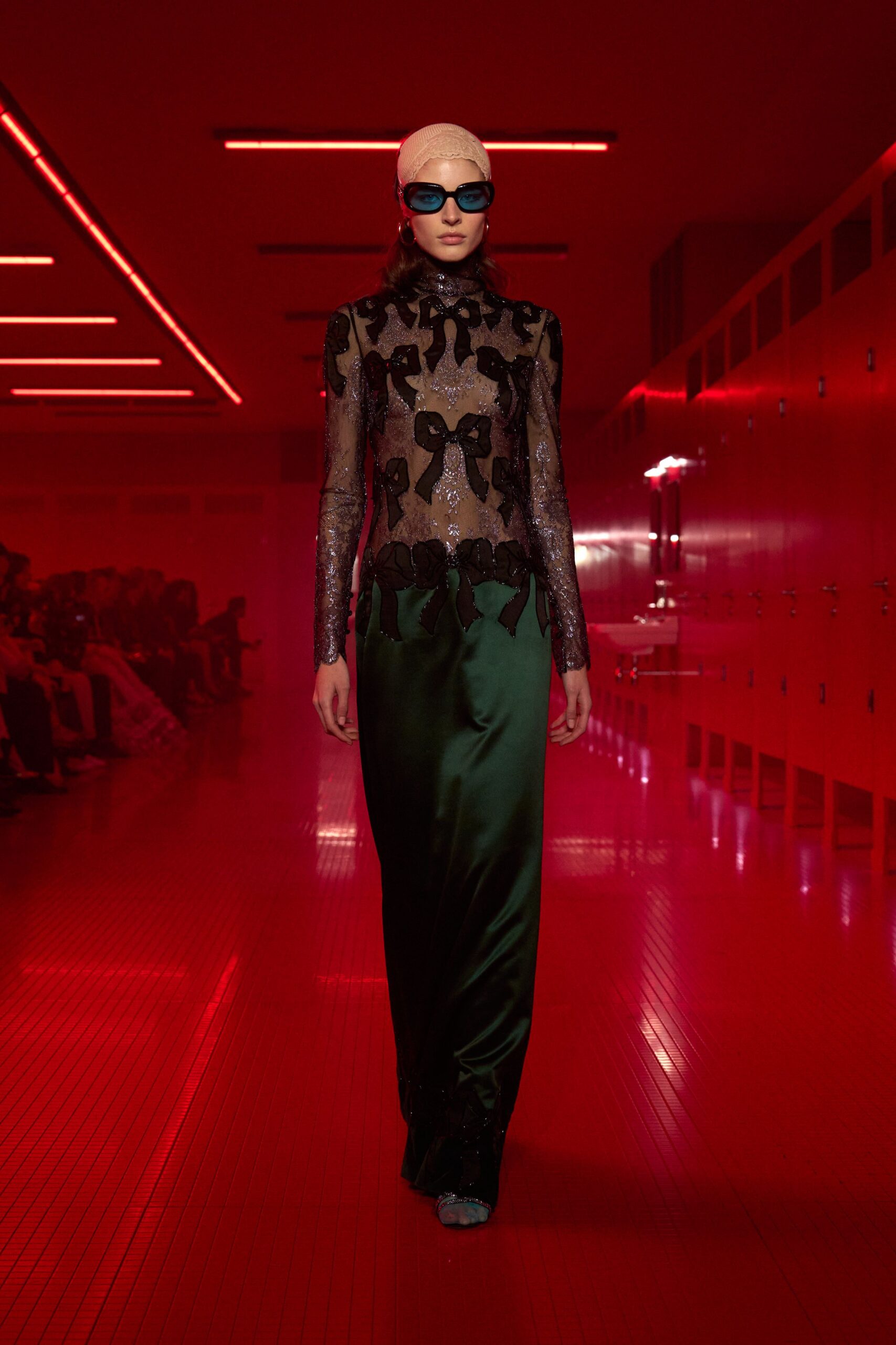 black and green embellished gown with sunglasses