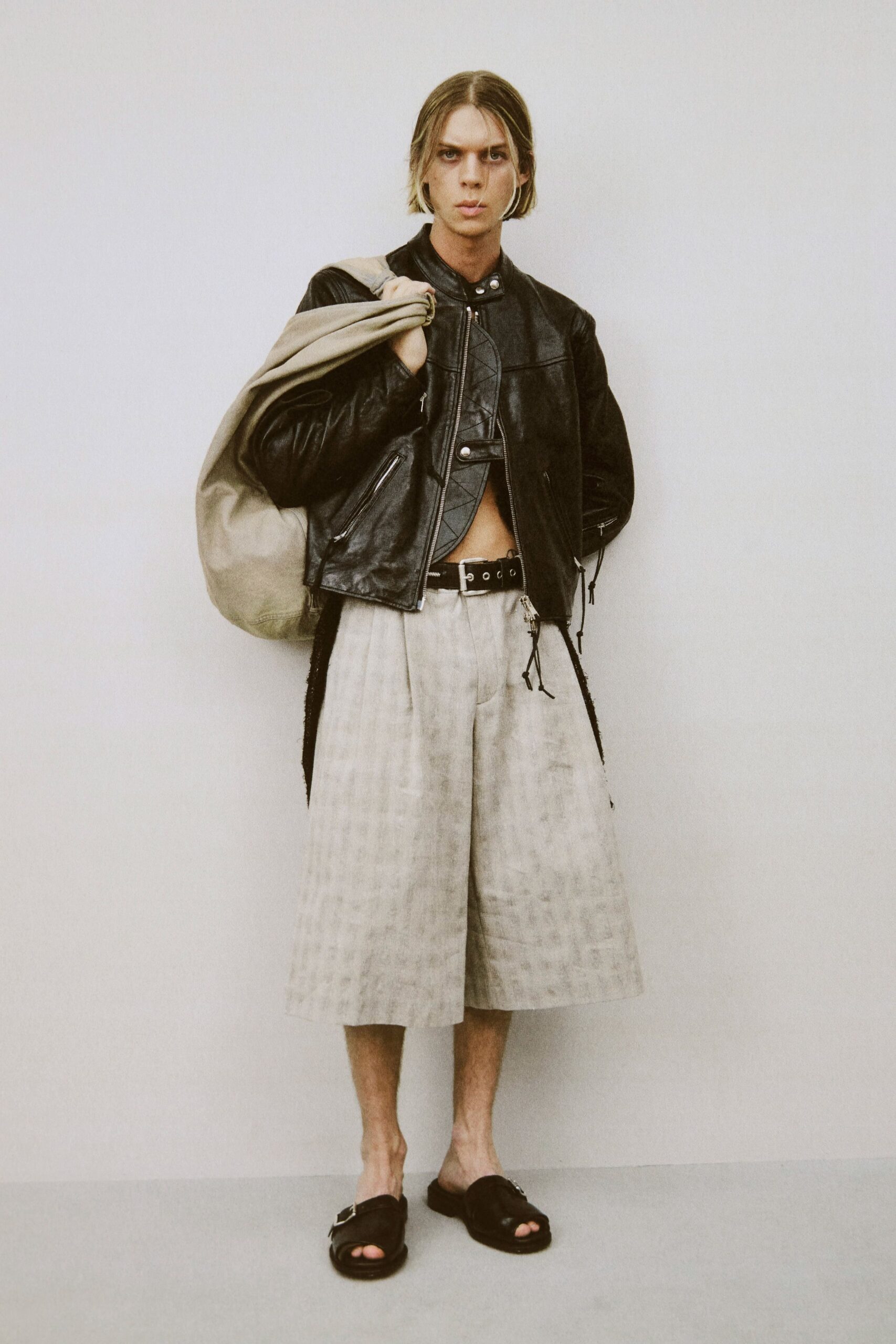 black leather jacket with beige bag