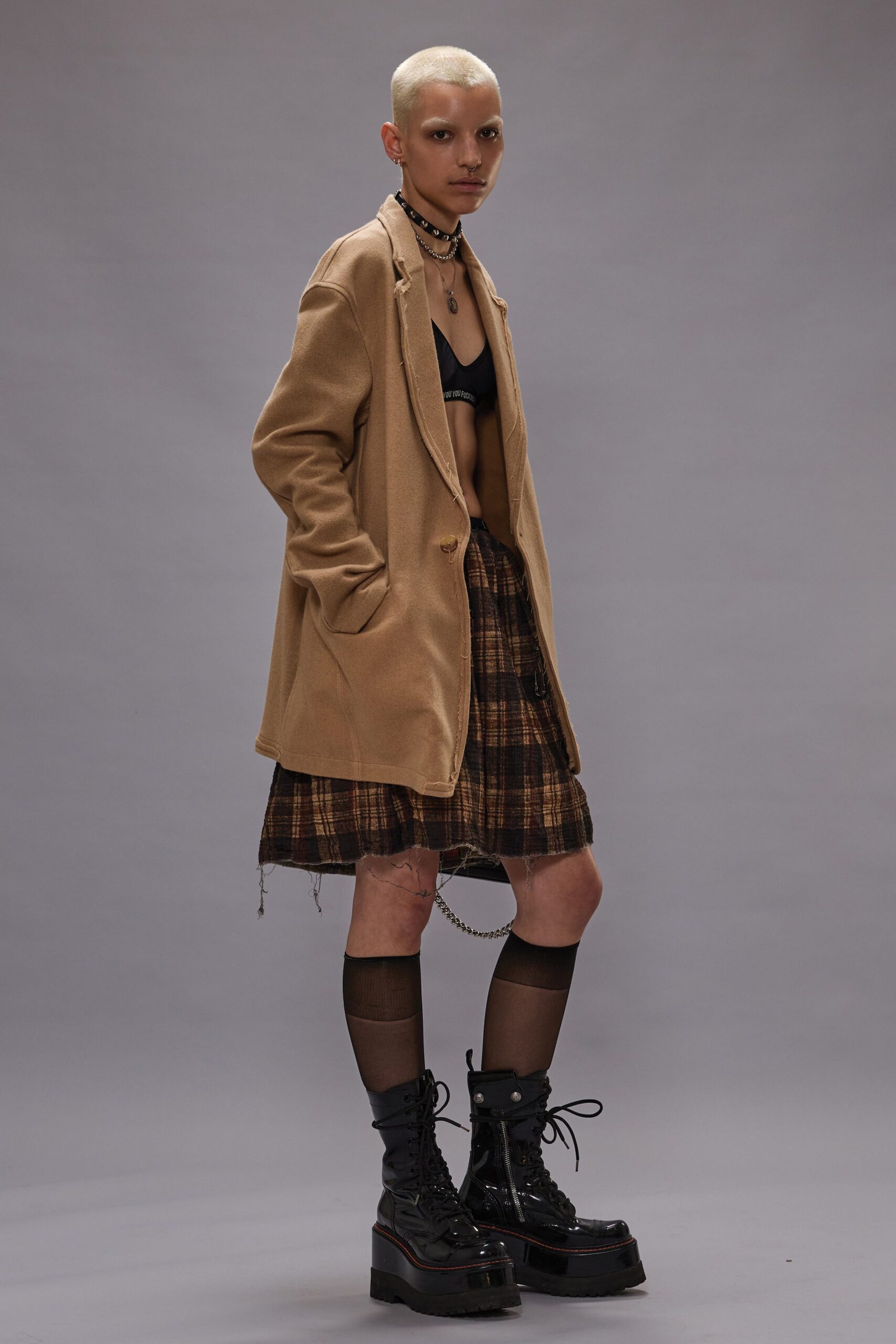 beige coat black bra mini skirt