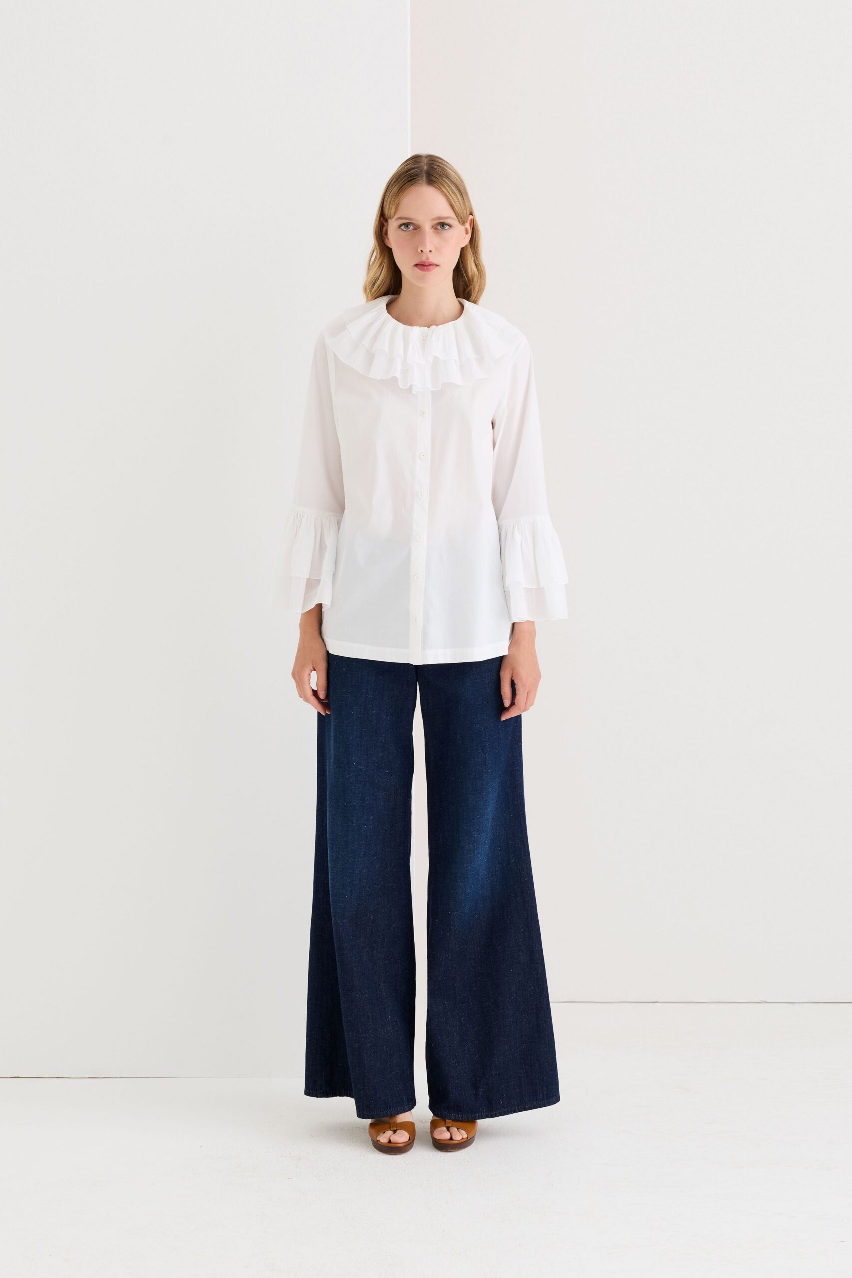 white ruffled shirt with wide-leg pants