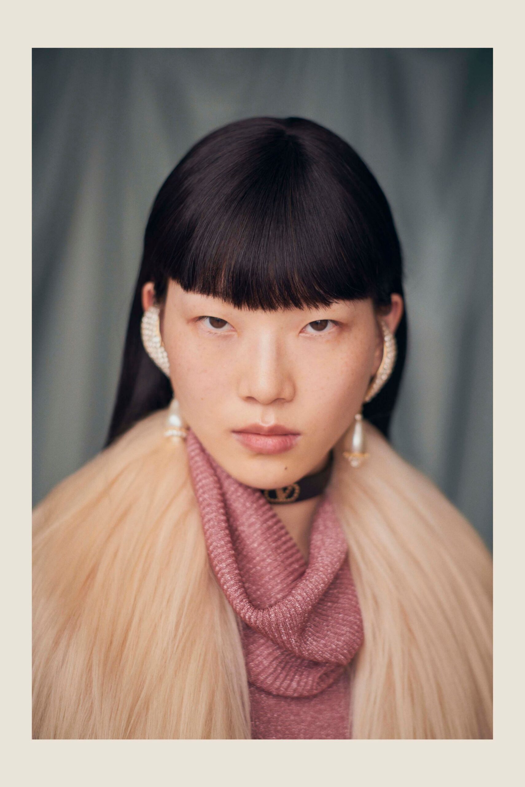 pink fitted top with beige fur coat