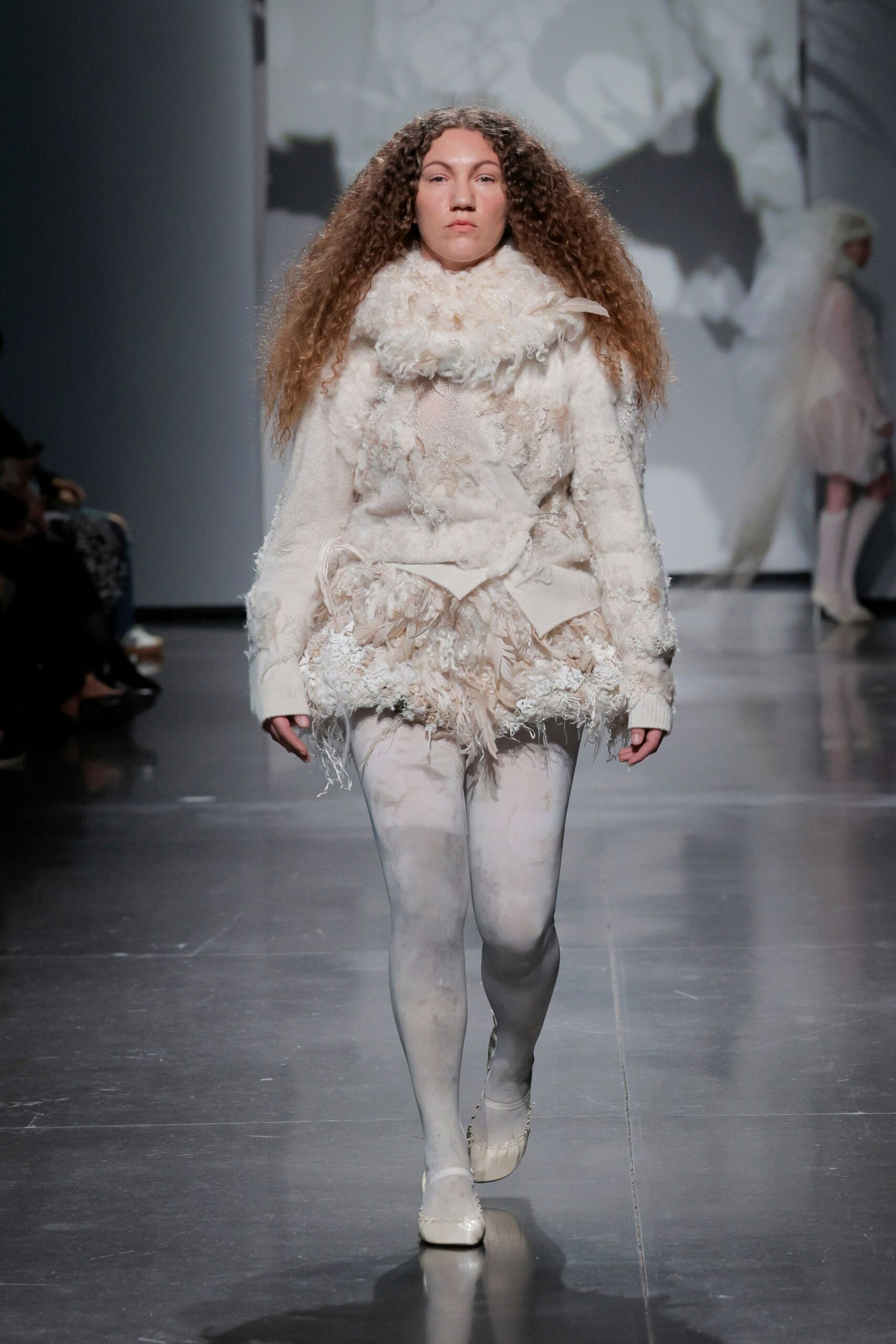 white wool relaxed sweater with beige shorts