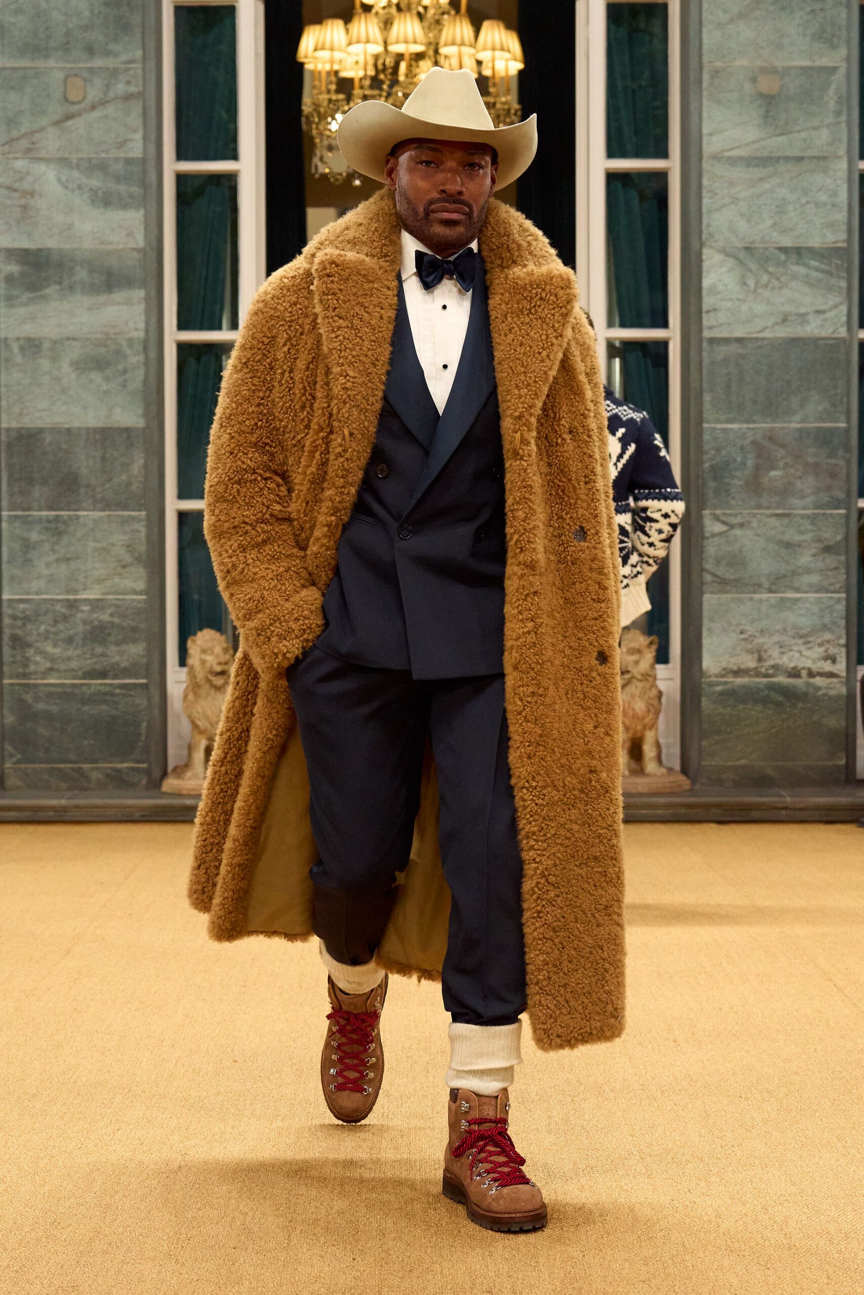 brown faux-fur coat with navy suit