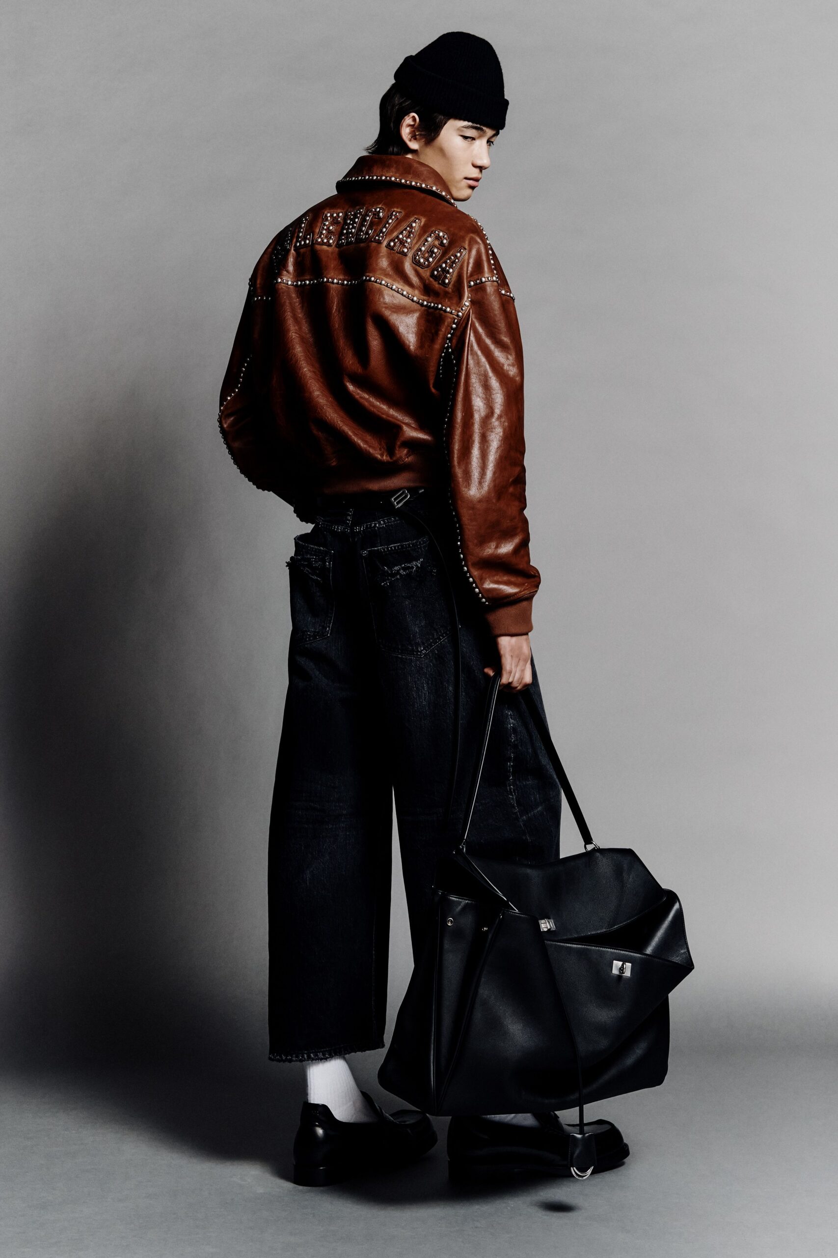 brown leather jacket with black pants