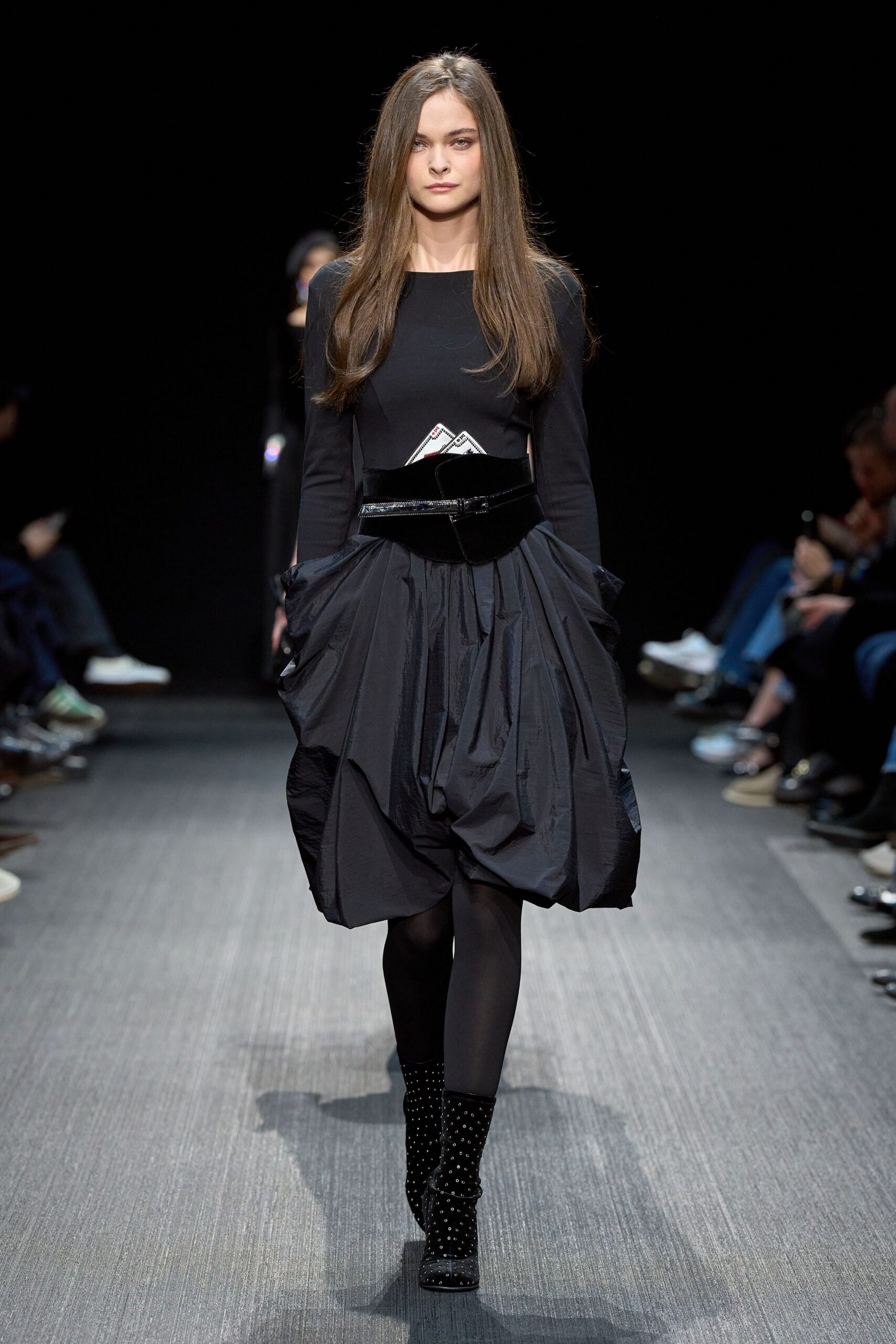 black fitted top and pleated skirt