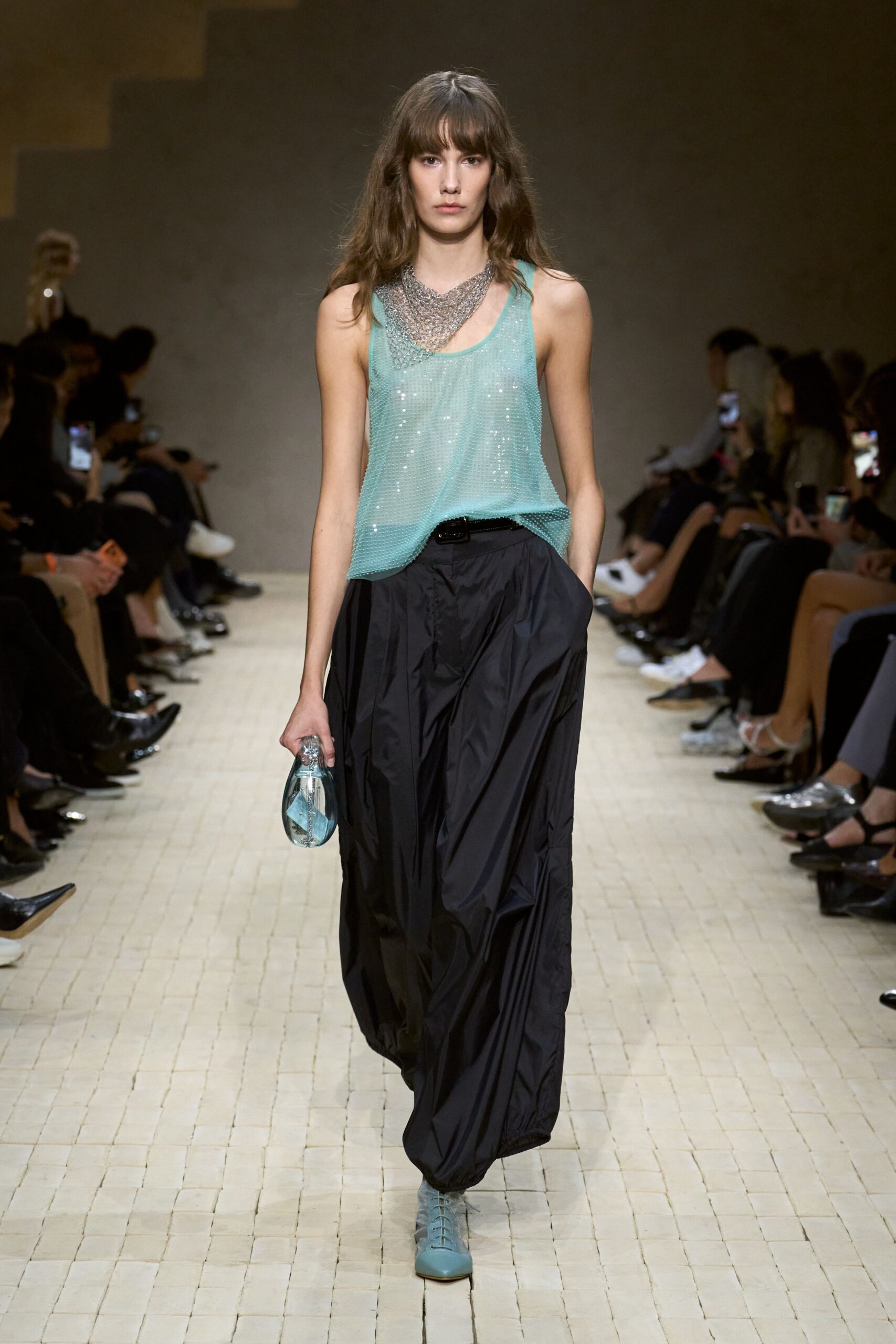 teal sequined sleeveless top with black pants