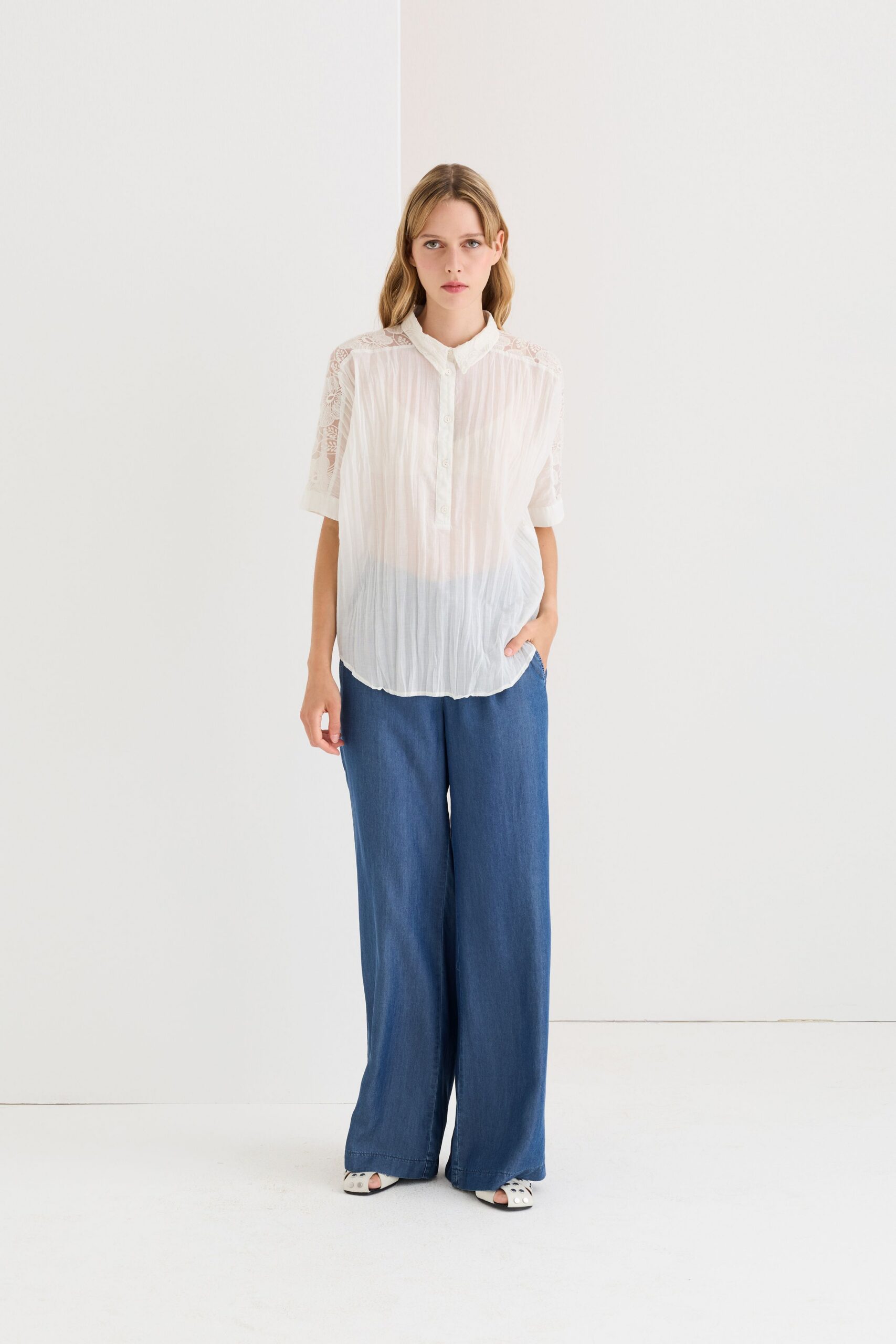 white relaxed shirt with blue wide-leg pants
