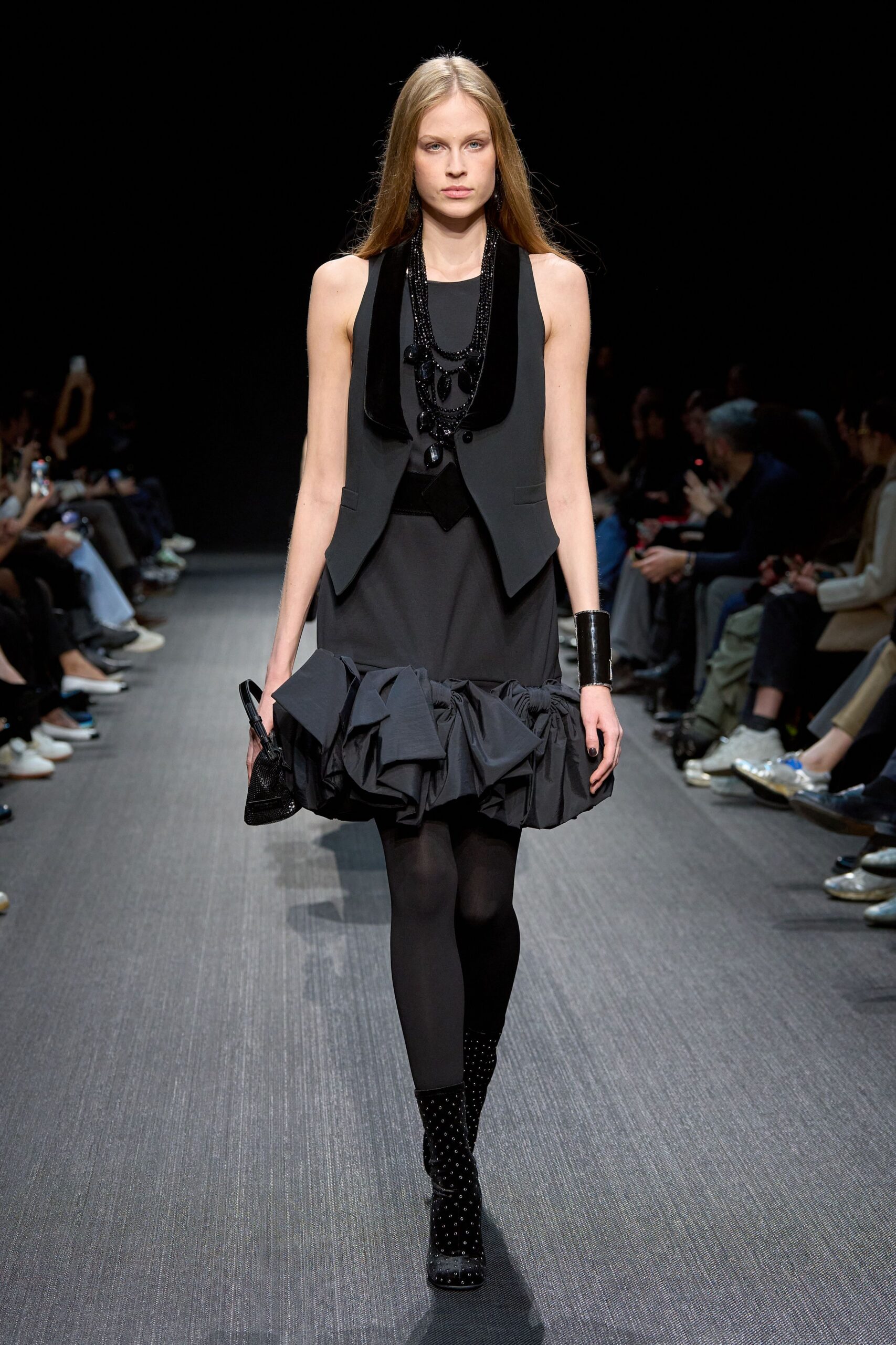 black fitted vest and mini skirt